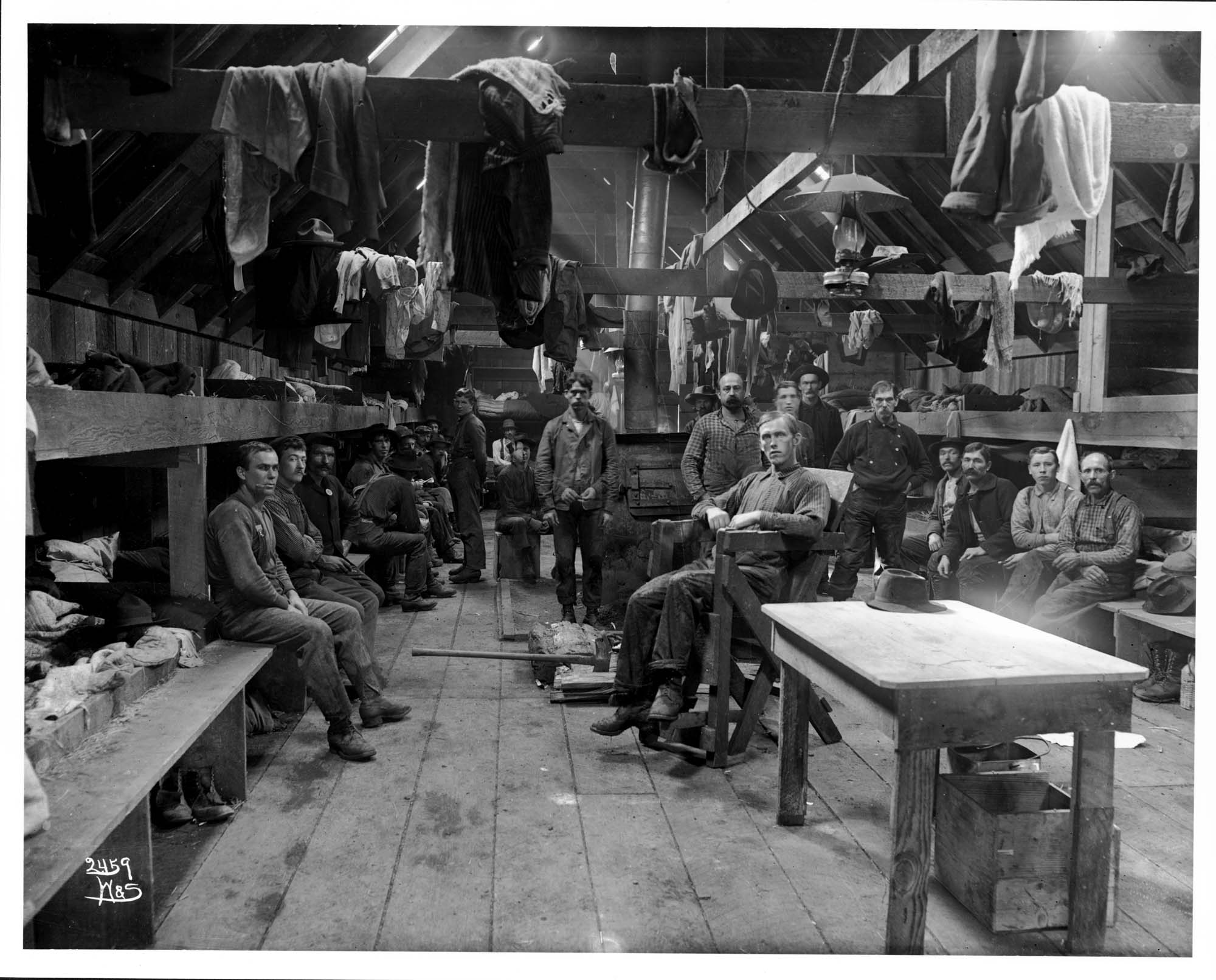 Image of Loggers in a logging camp bunkhouse, circa 1903