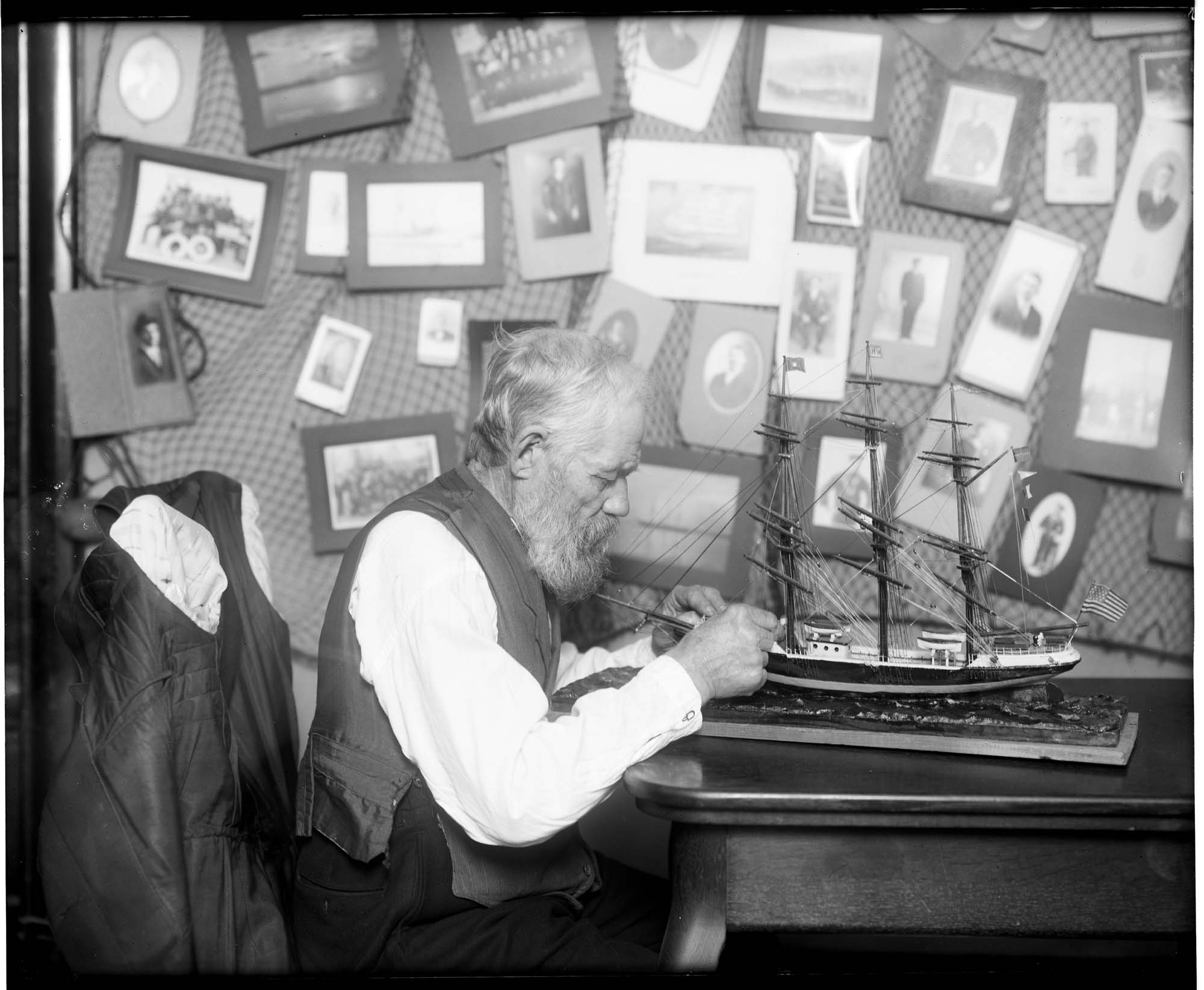 Image of Old sailor with ship model, circa 1906