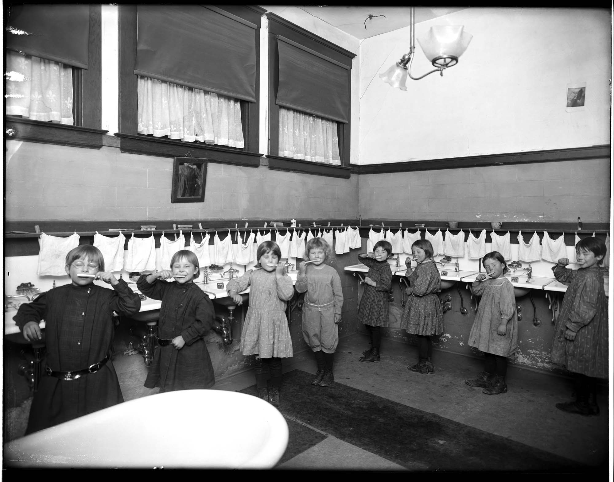 Image of Children brushing their teeth in a children's home, circa 1911