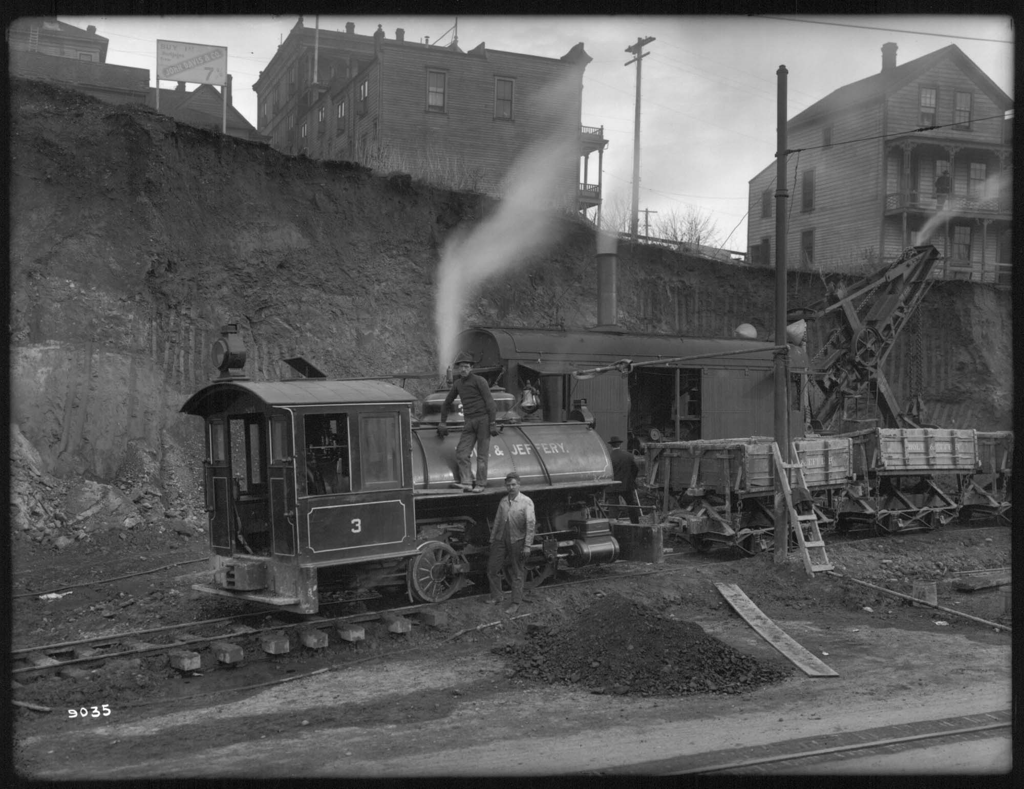 Image of Steam shovel and locomotive at Denny regrade site, Seattle, circa 1909