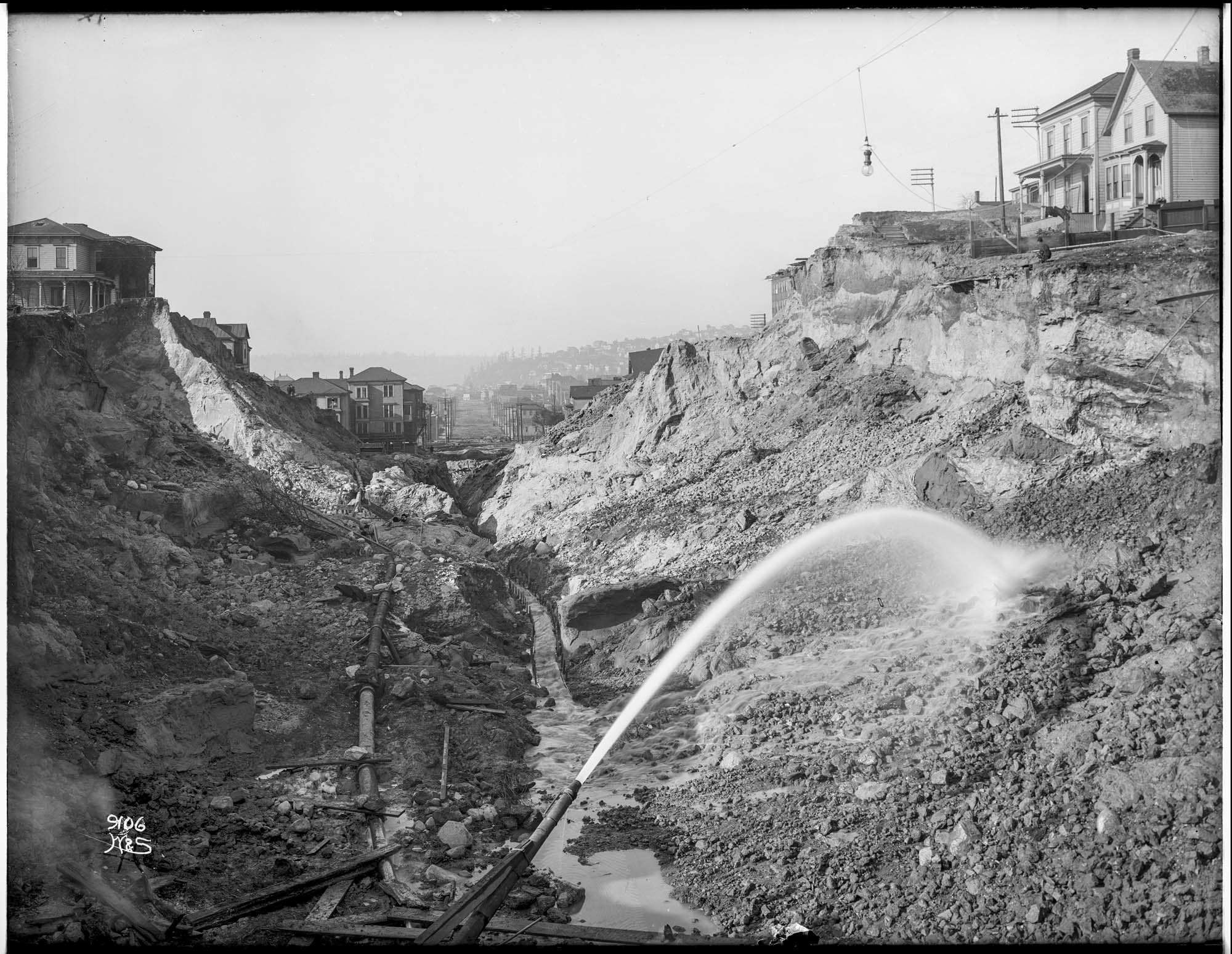 Image of Using water hoses to regrade Denny Hill, circa 1909
