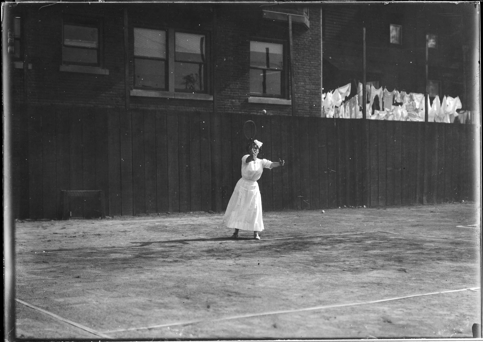 Image of Woman playing tennis, probably in Seattle, circa 1910