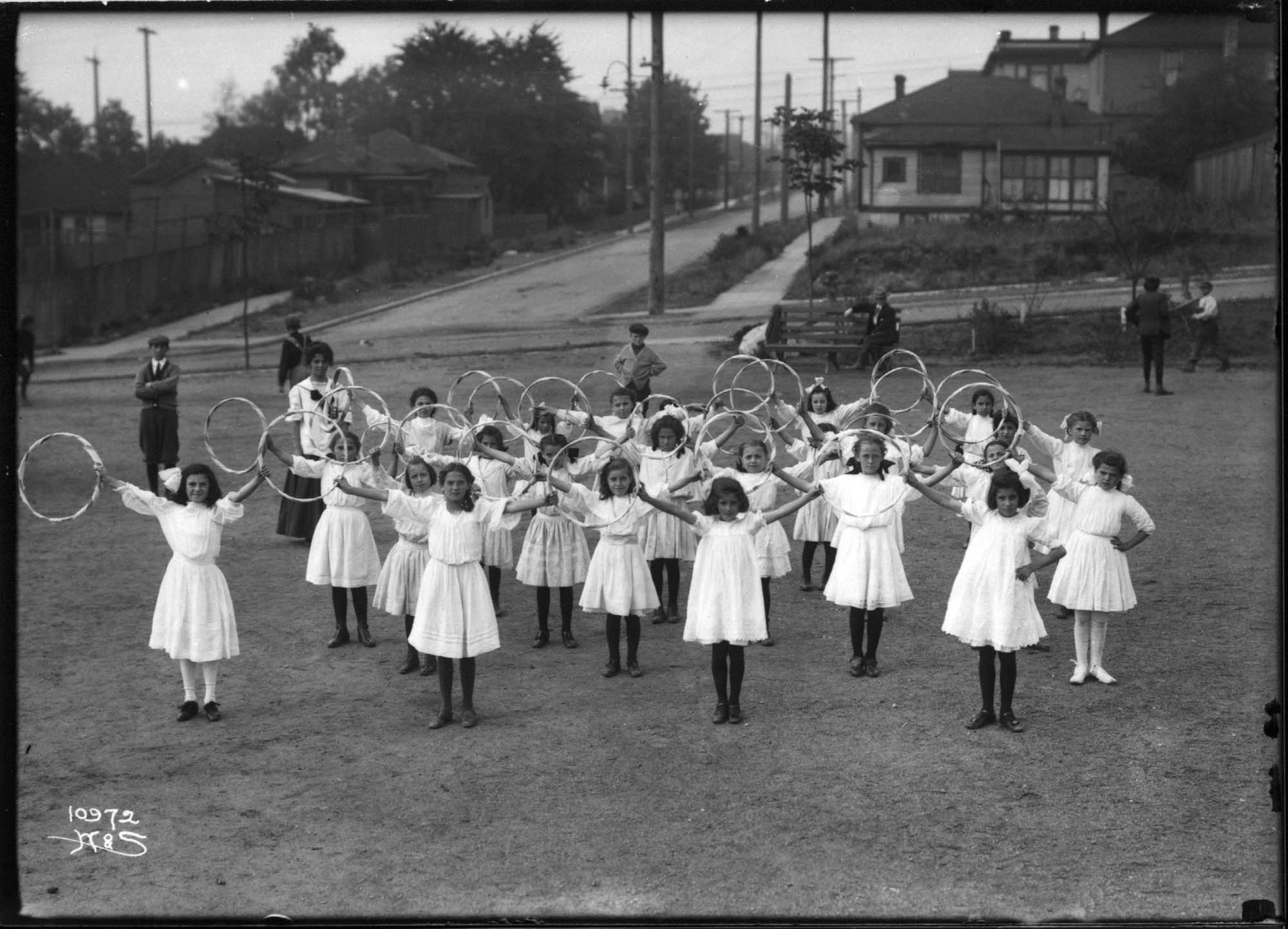 Image of Girls with hoops in playground, circa 1910