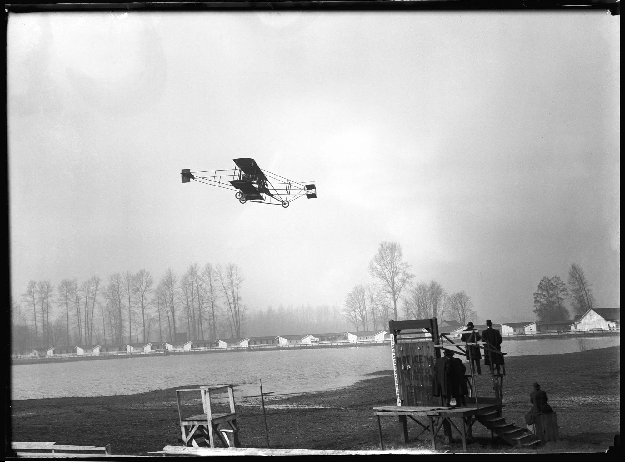 Image of Charles Hamilton's biplane in flight, 1910