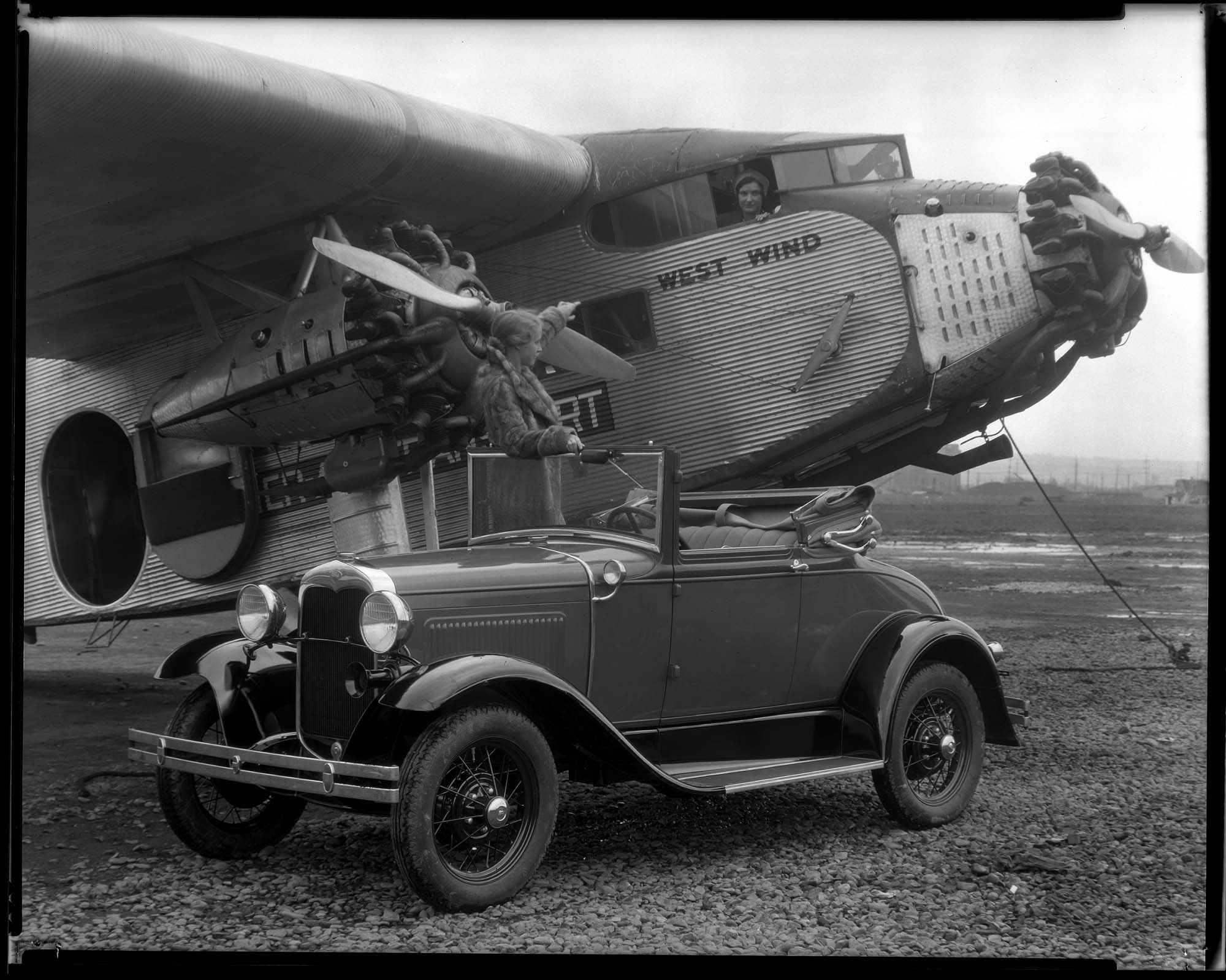 Image of Ford trimotor airplane and Ford automobile, circa 1940