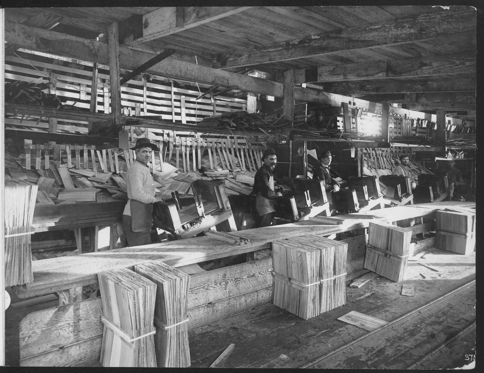 Image of Men packing shingles, circa 1915