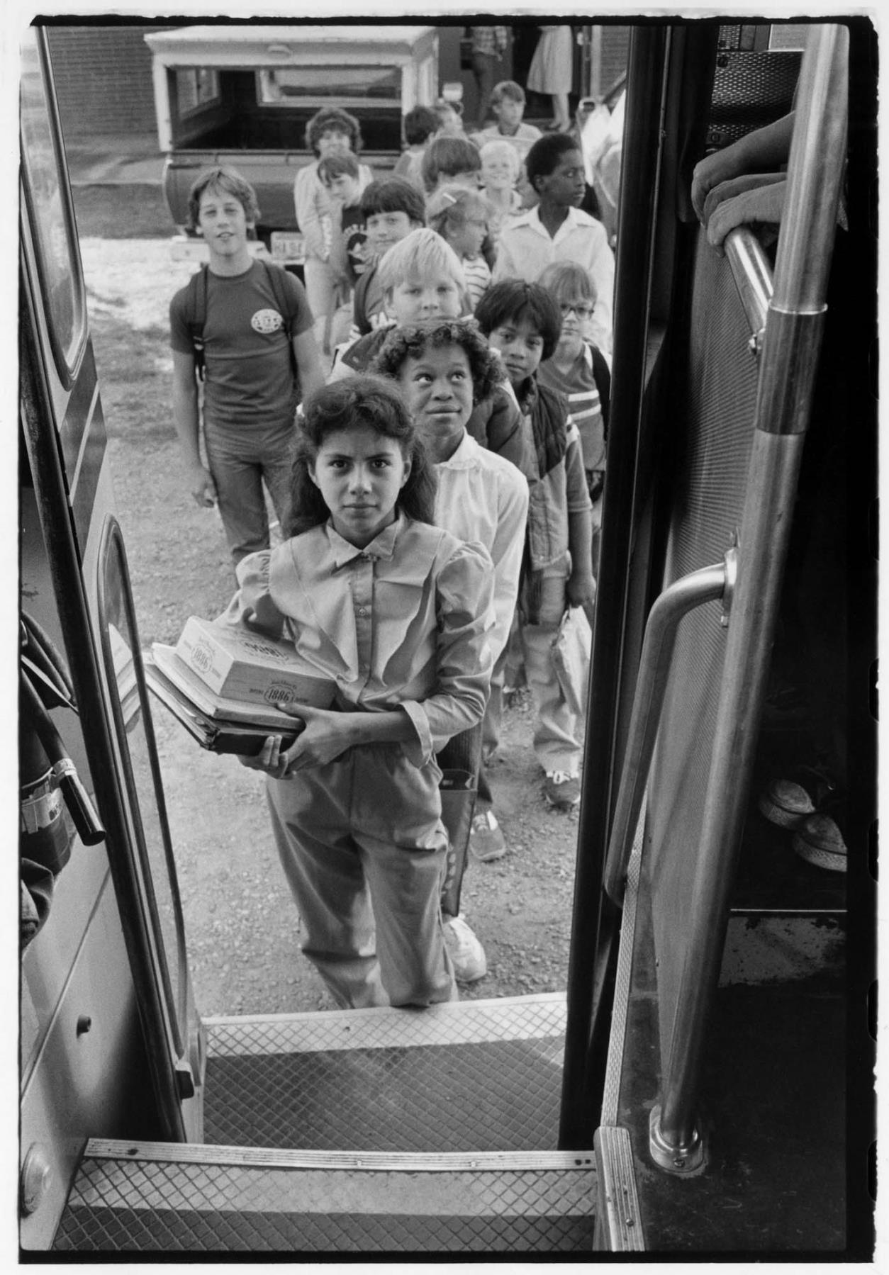 Image of Children entering a school bus, Grandview, Washington, 1983