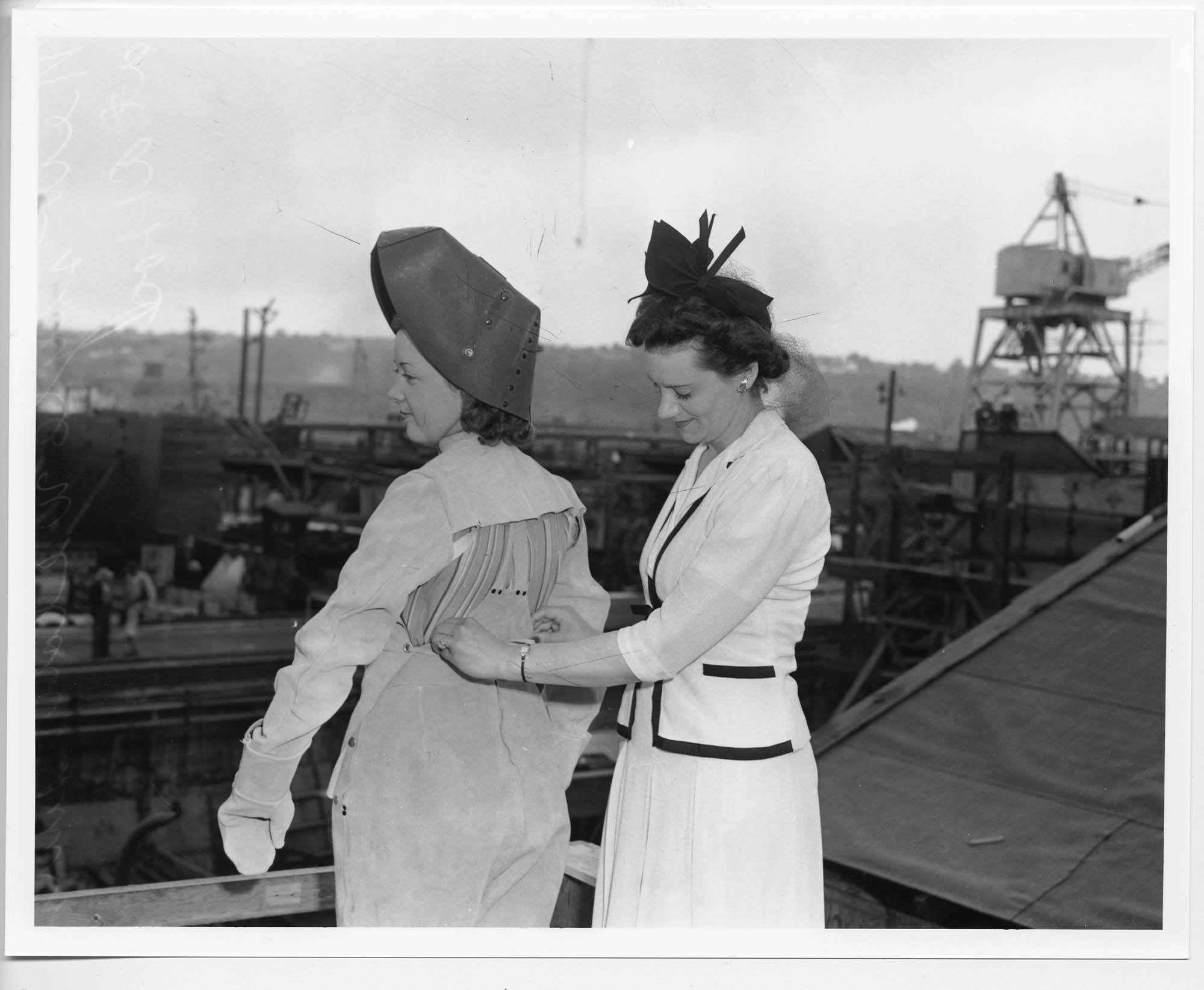 Image of Women demonstrating welding suit at Associated Shipyards, Seattle, 1943