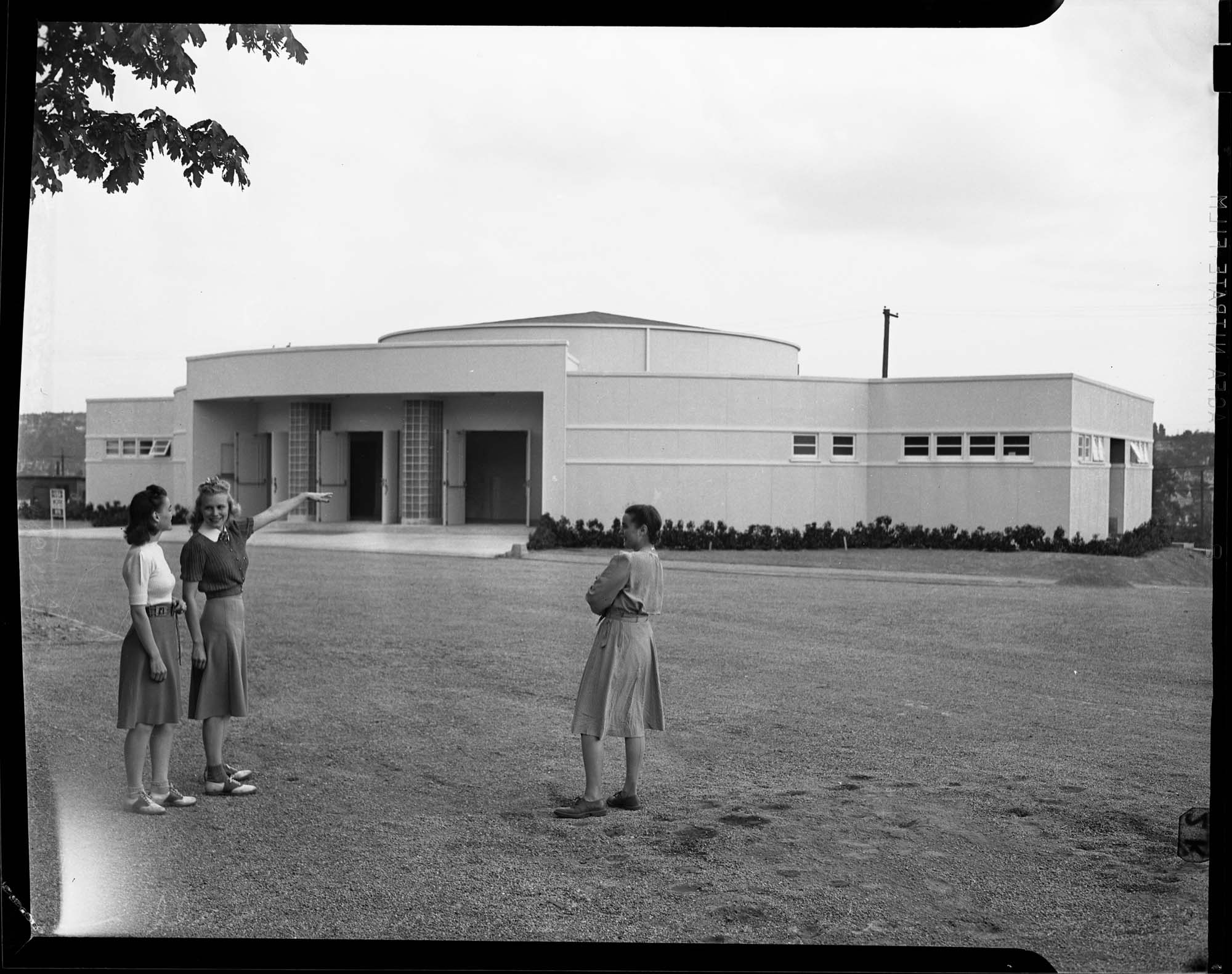 Image of Three women standing in front of the Hughes Penthouse Theatre on the University of Washington campus, Seattle, May 1940