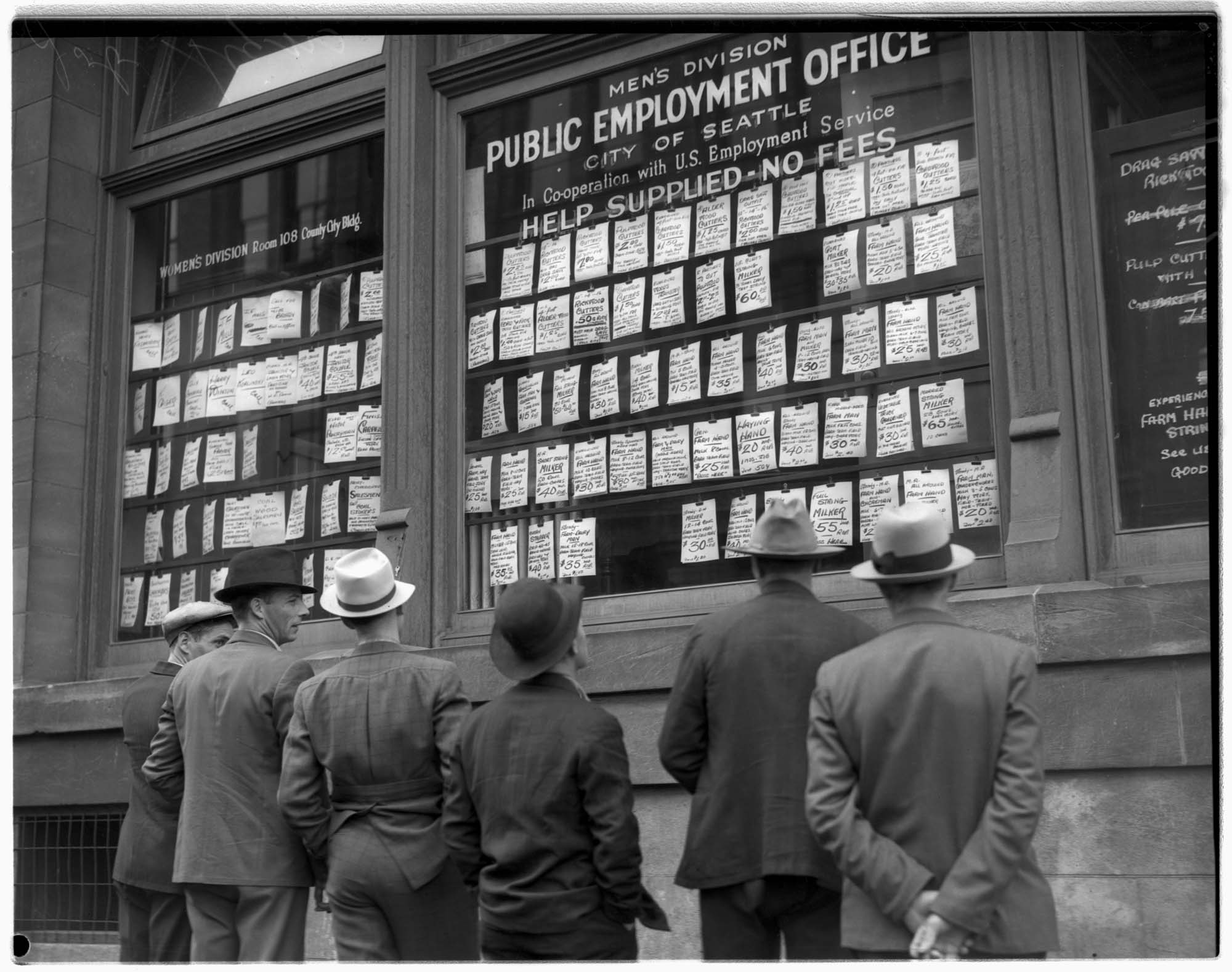 Image of Public employment office exterior showing men looking at listings, Seattle, 1936