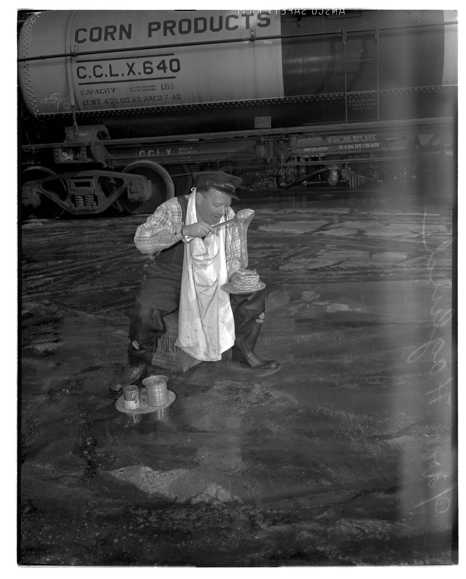 Image of Ivar Haglund with pancakes in the street, Seattle, 1947