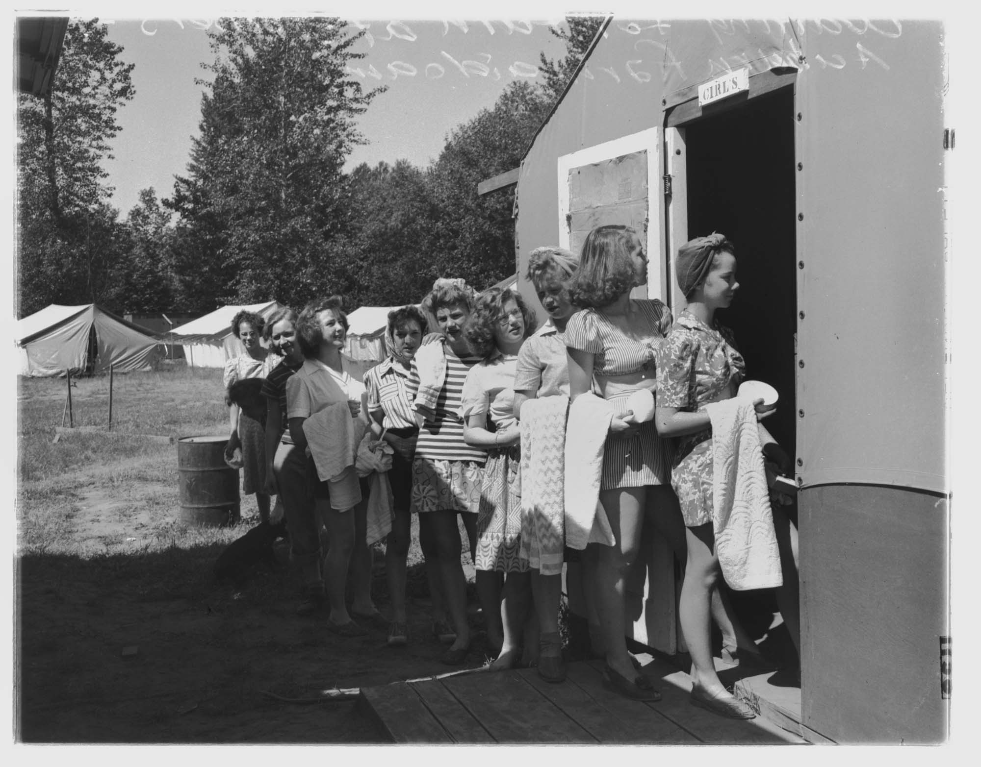 Image of Young women farm volunteers waiting for the shower, June 28, 1943