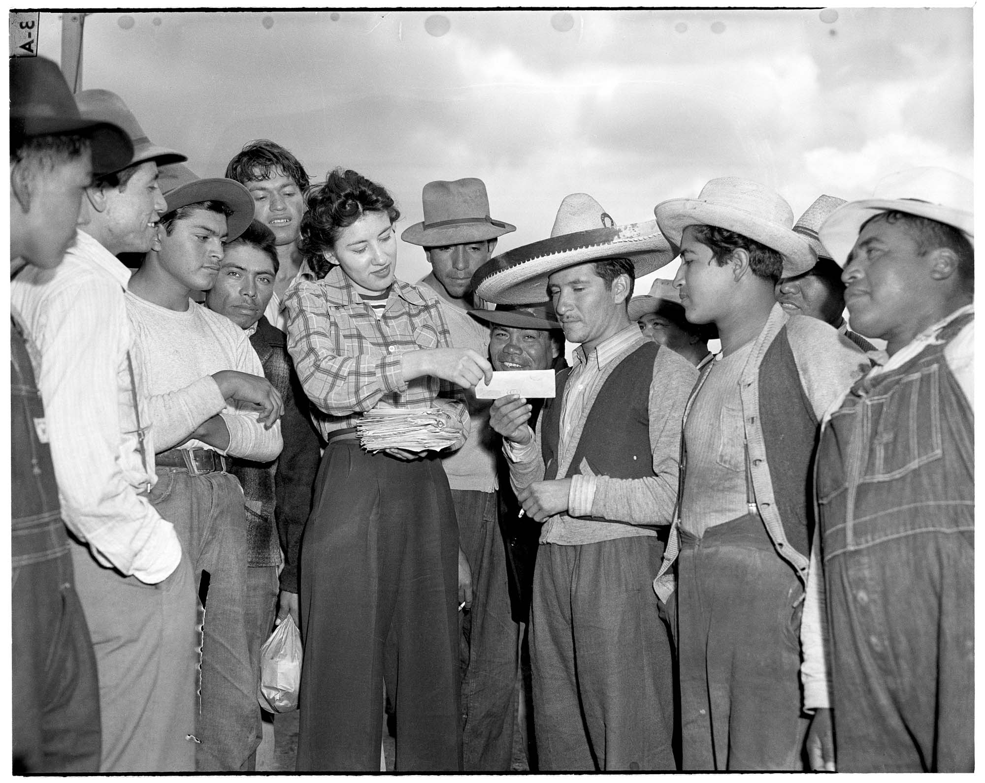 Image of Mexican farm workers receiving paychecks, Skagit Valley, 1943