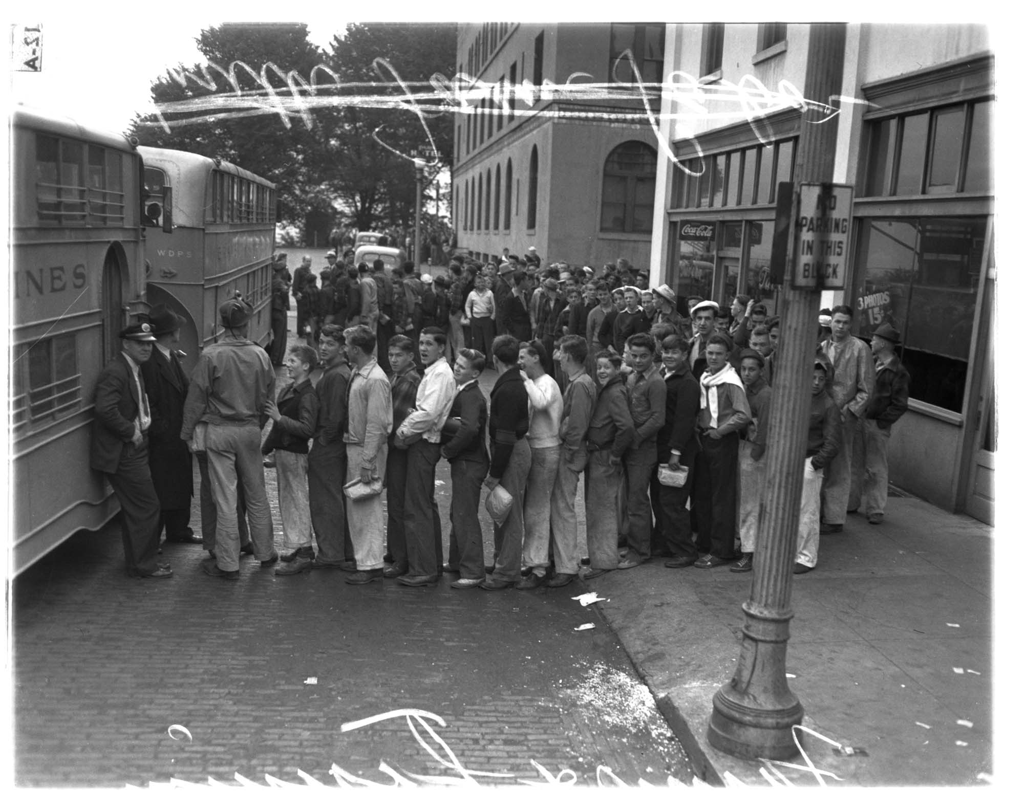 Image of Young men board buses for the Victory Youth Farm Aid Corps, 1942
