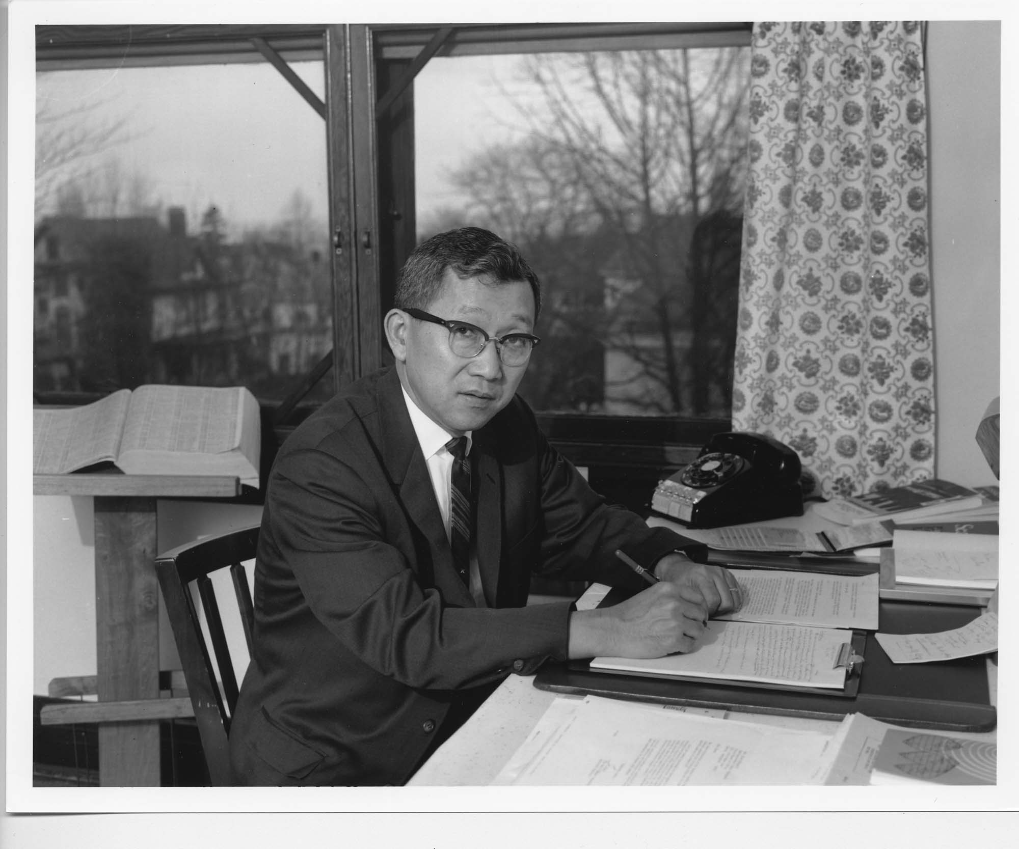 Image of Mineo Katagiri seated at a desk, possibly in Seattle, 1966
