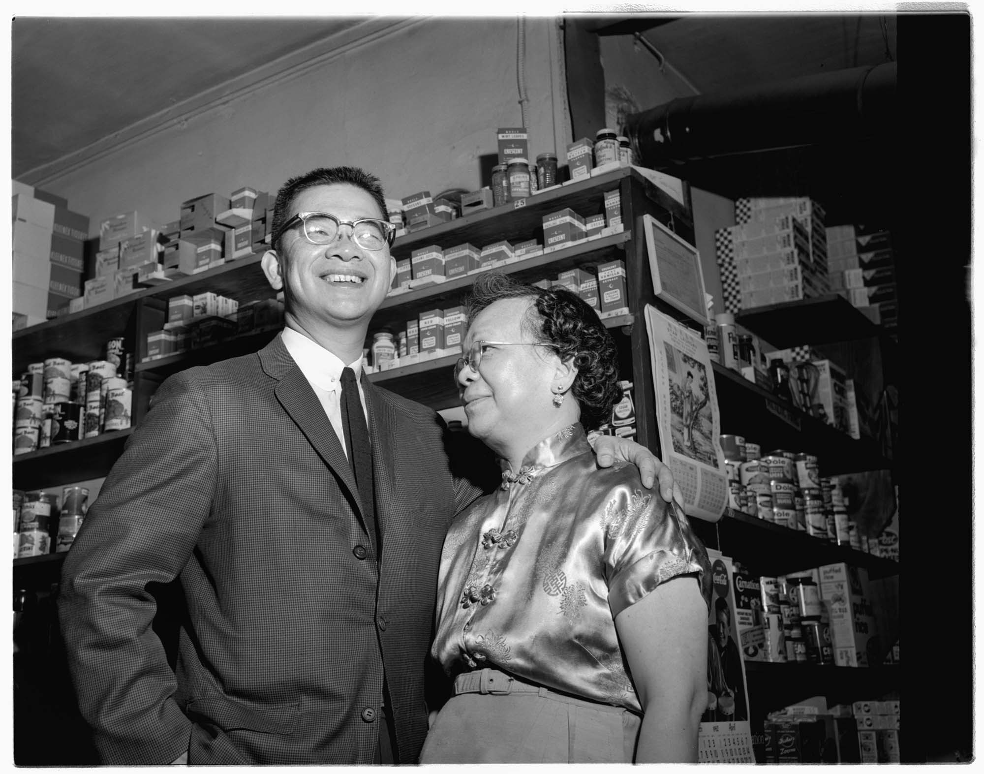 Image of Wing Luke and his mother inside a store, probably in Seattle, 1962