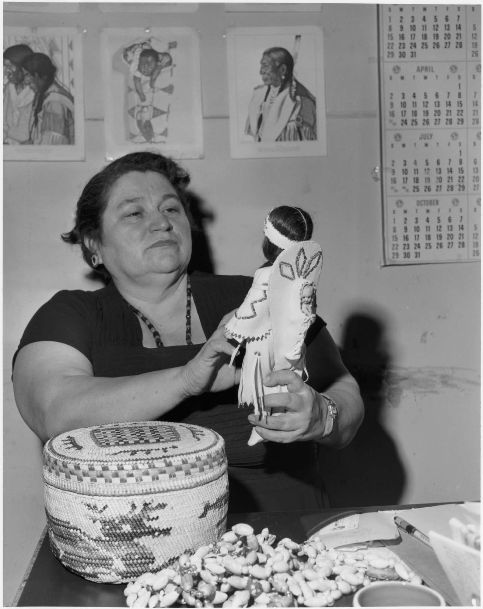 Image of Pearl Warren examining Native American art, Seattle, 1962