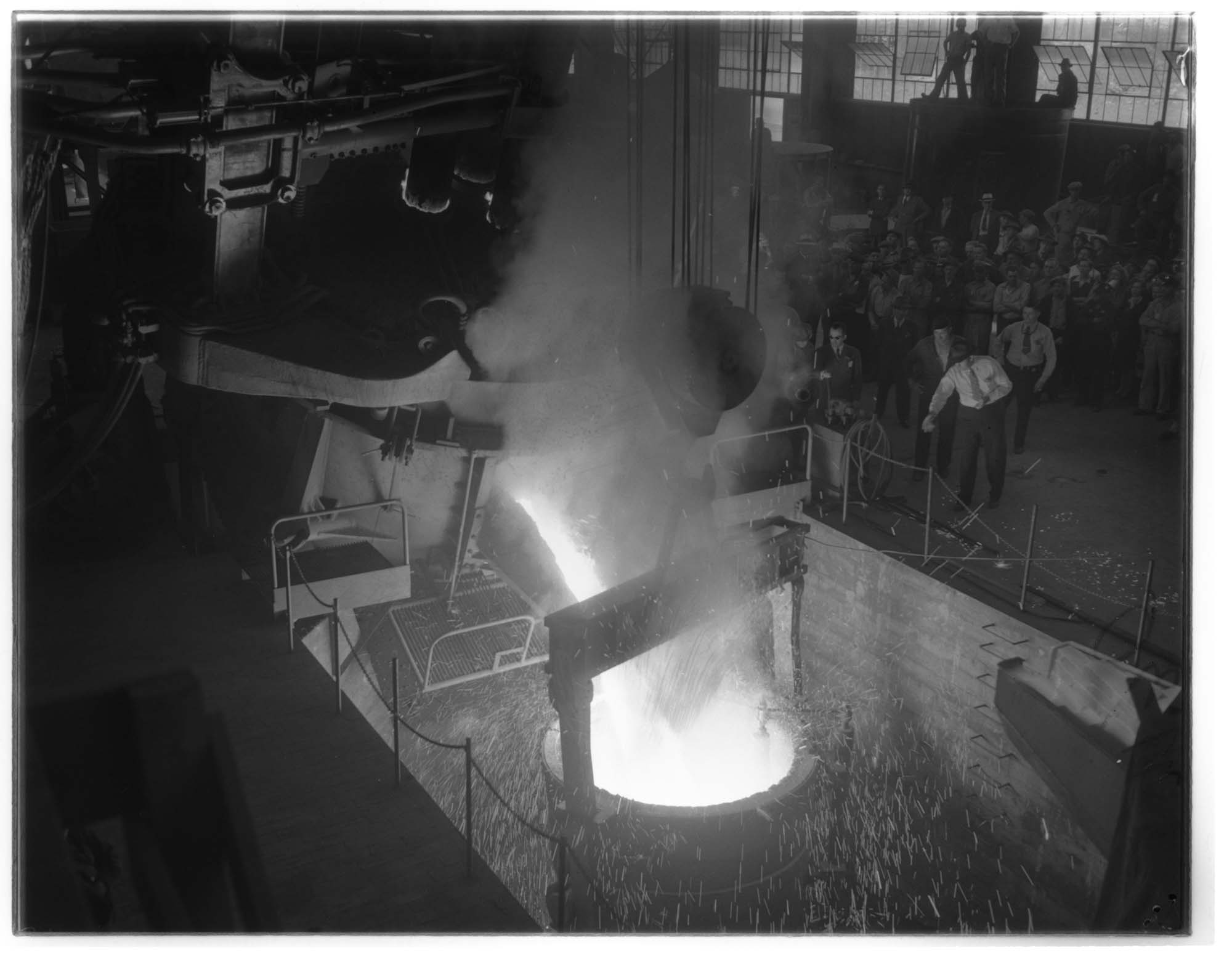 Image of Molten metal being poured into a crucible at Isaacson Iron Works, Seattle, 1943