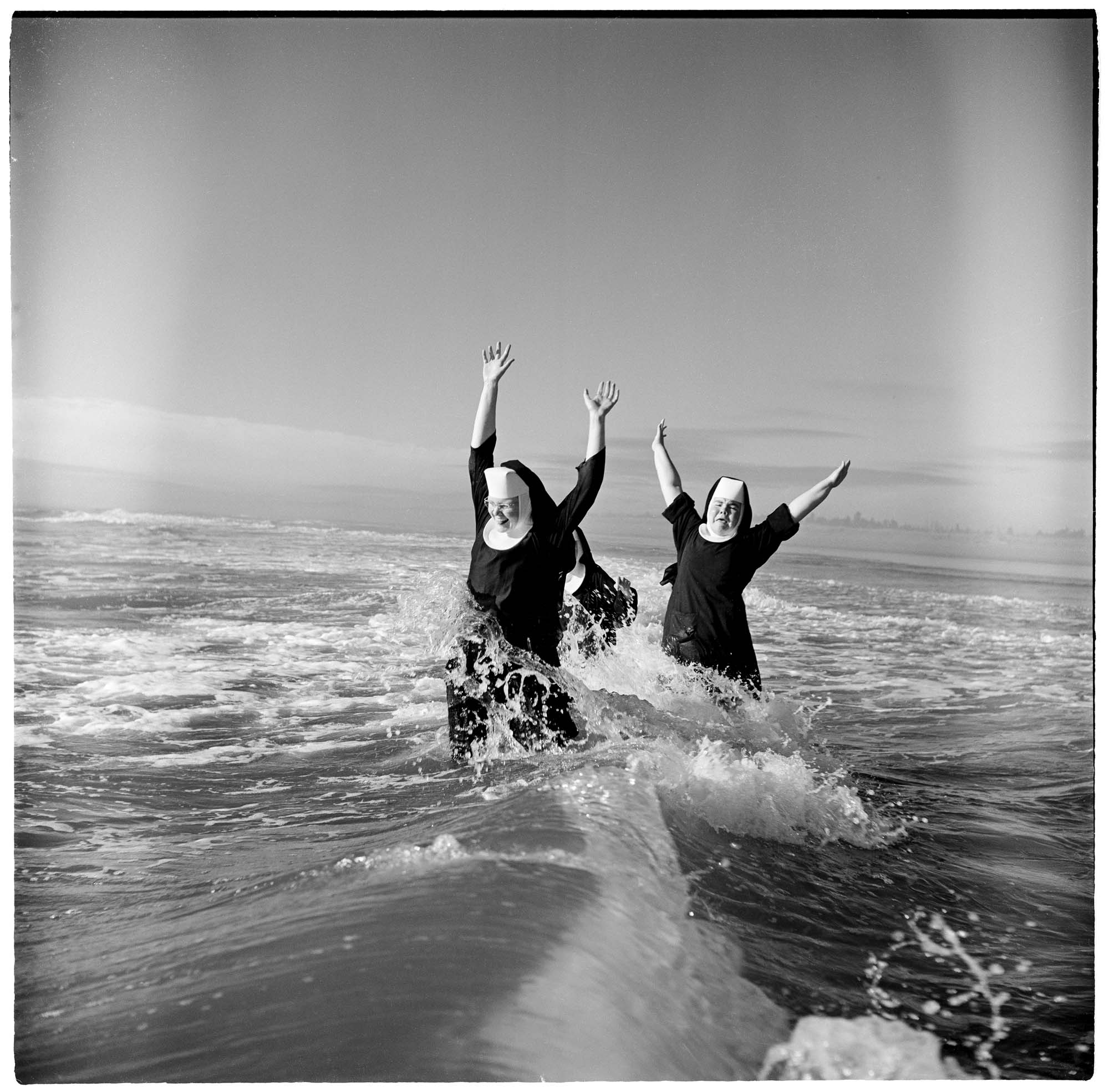 Image of Seattle-area nuns playing in the surf, Grayland, 1960