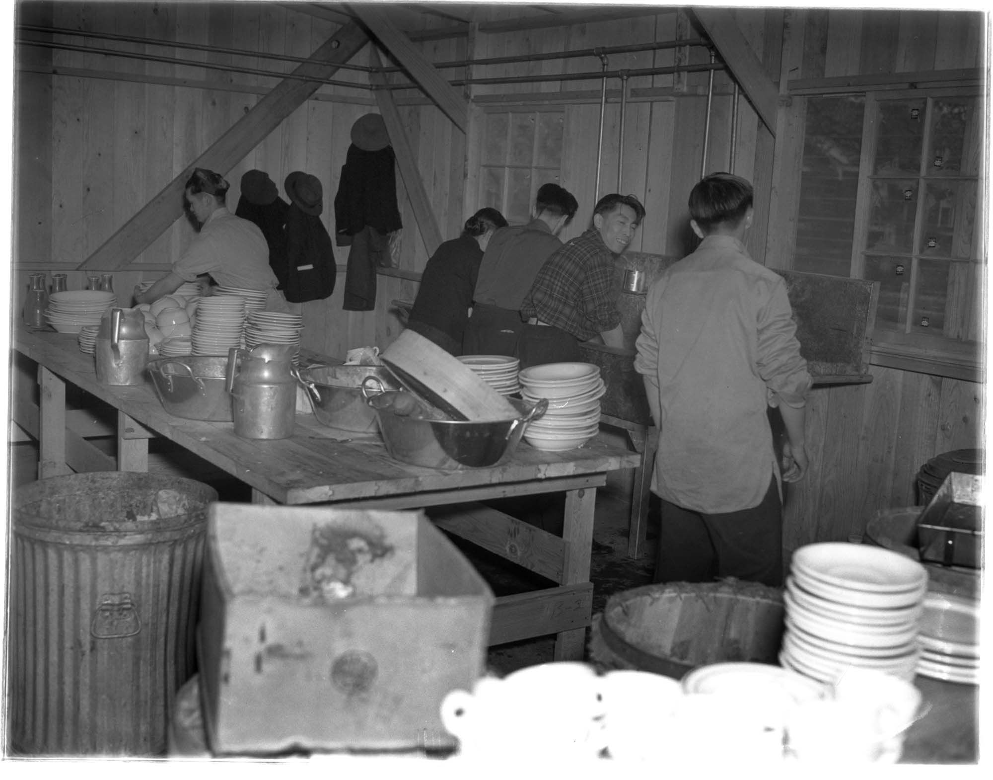 Image of Japanese American incarcerees washing dishes at the Puyallup Assembly Center, Puyallup, 1942