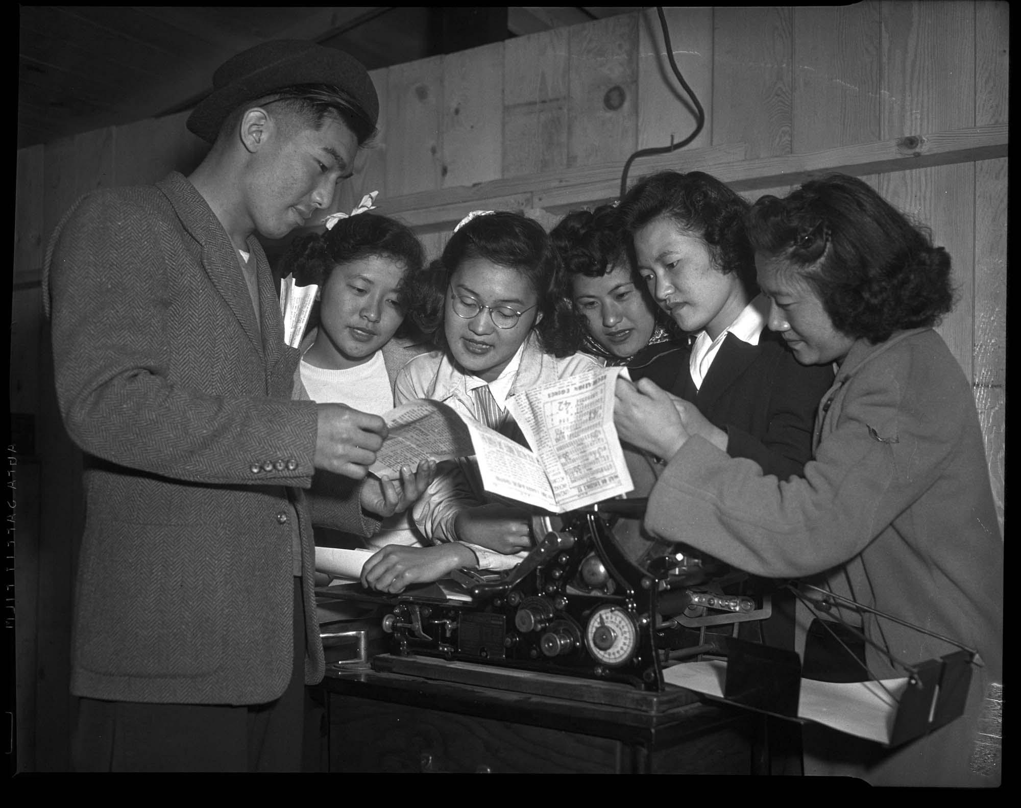 Image of Teenaged incarcerees with printing machine at the Puyallup Assembly Center, Puyallup, 1942