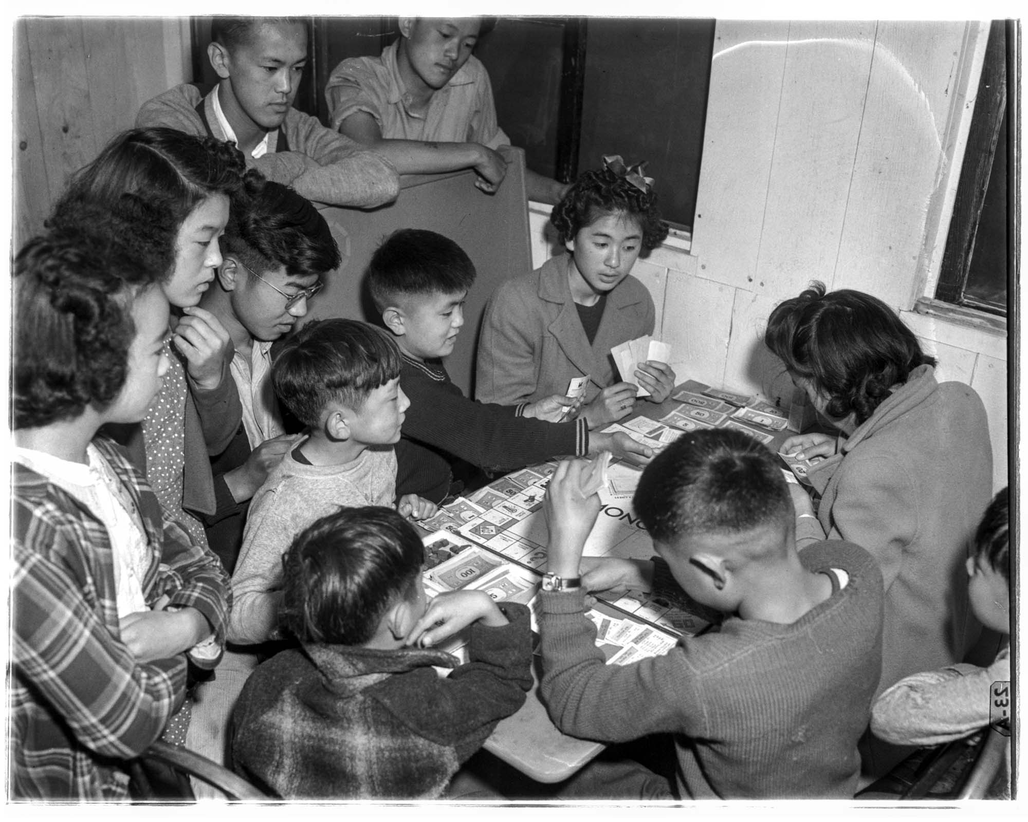Image of Incarcerated children playing Monopoly at the Puyallup Assembly Center, Puyallup, 1942