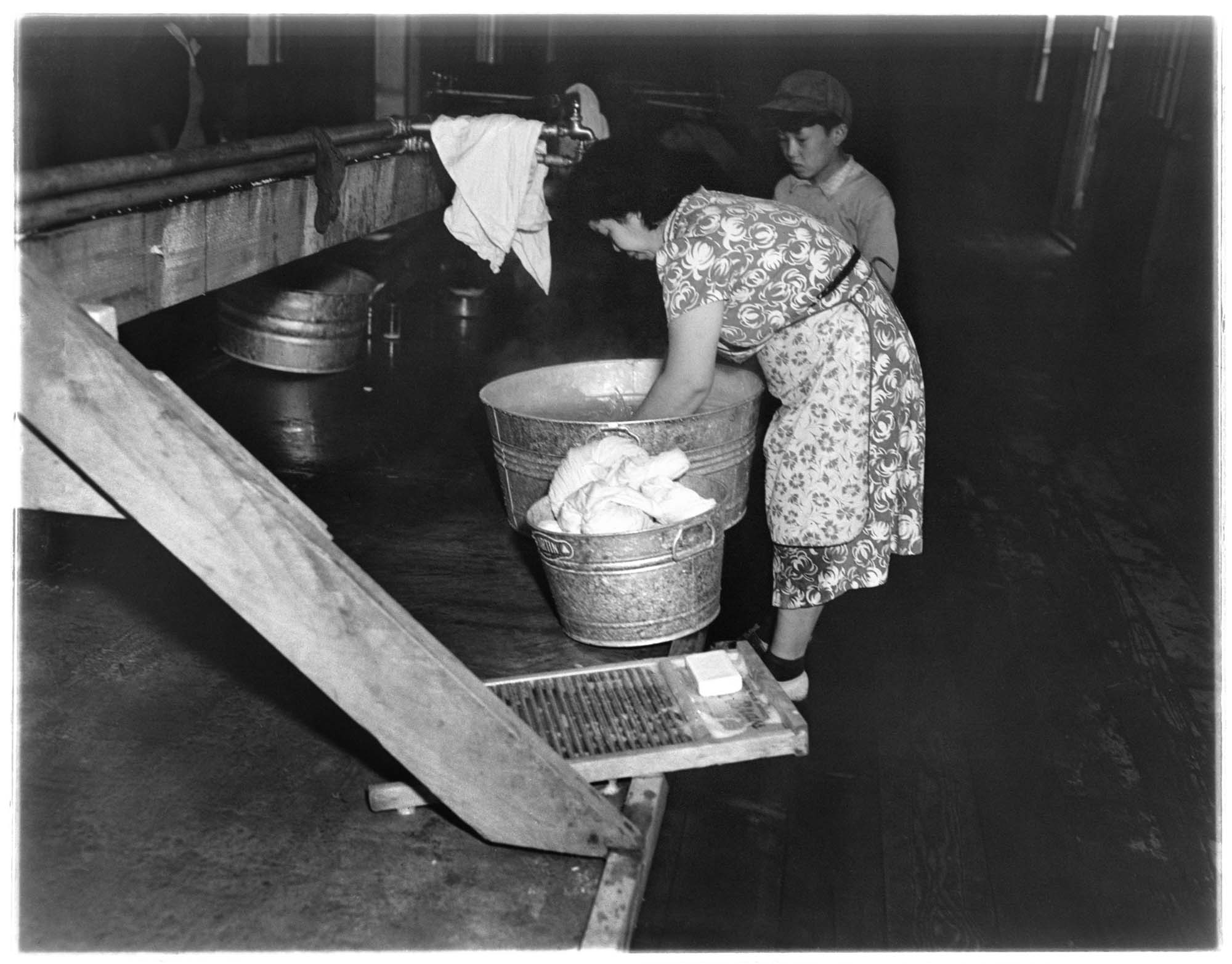 Image of Japanese American woman washing clothes at the Puyallup Assembly Center, Puyallup, 1942