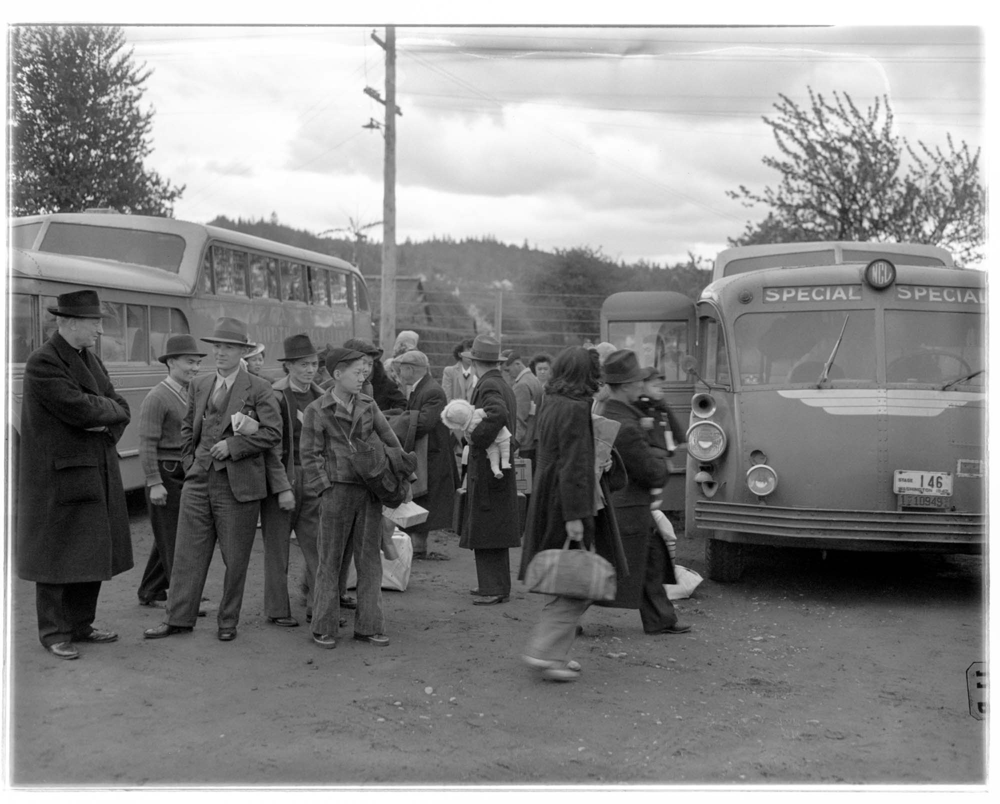 Image of Incarcerees arriving on buses at the Puyallup Assembly Center, Puyallup, 1942