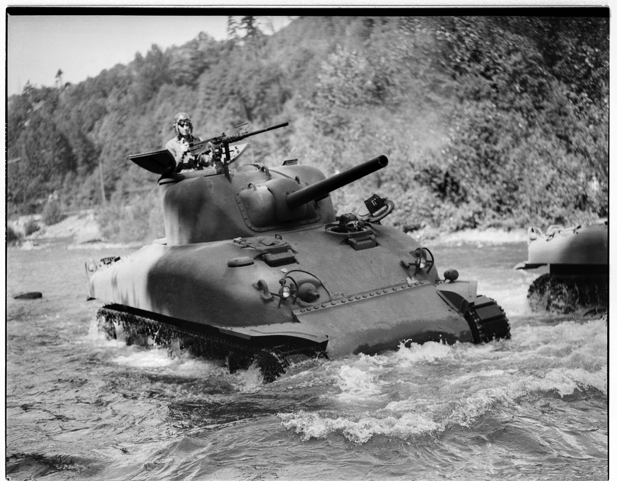 Image of Man test driving Sherman tank in river, Renton, 1942