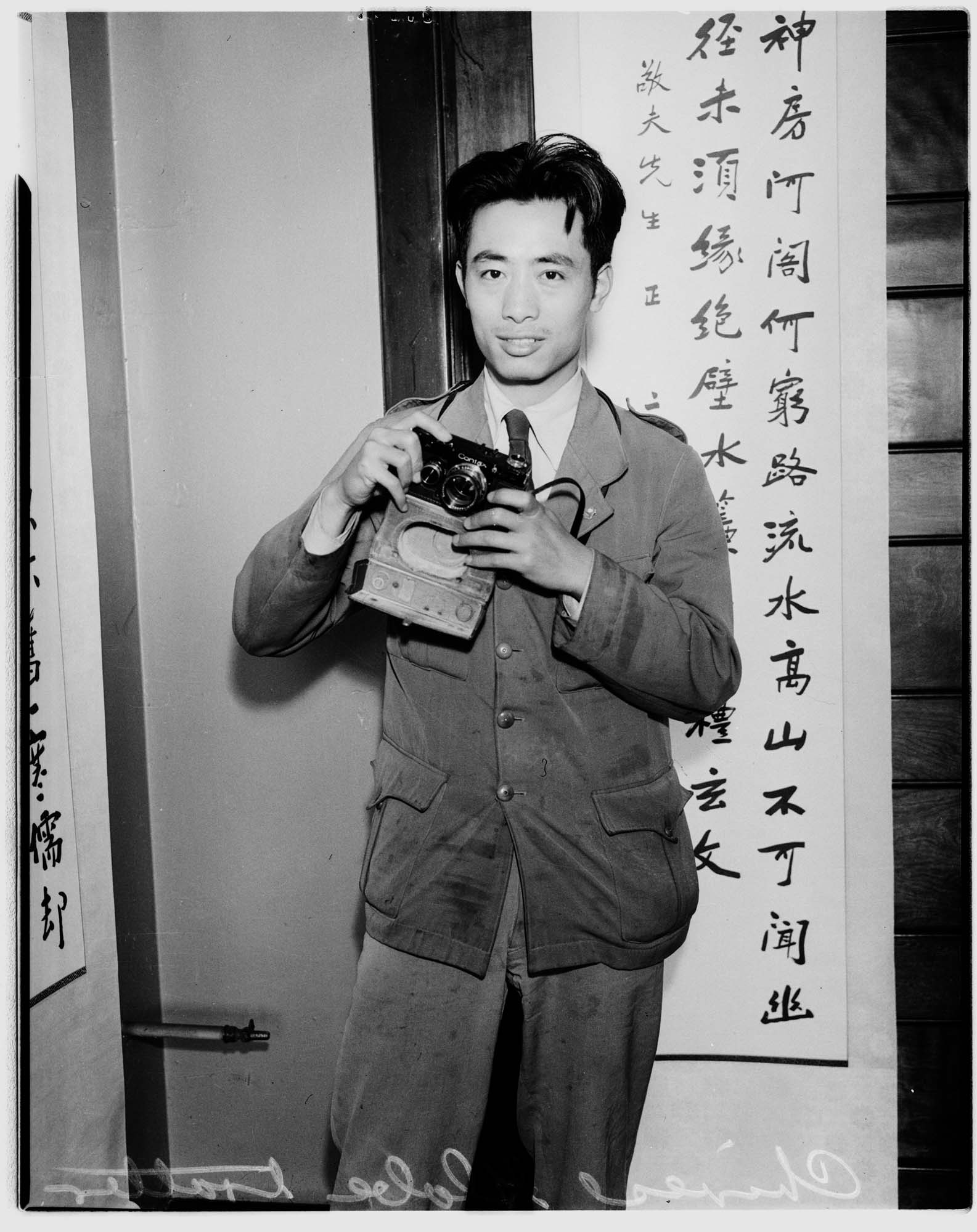 Image of Chinese man with camera, Seattle, 1935