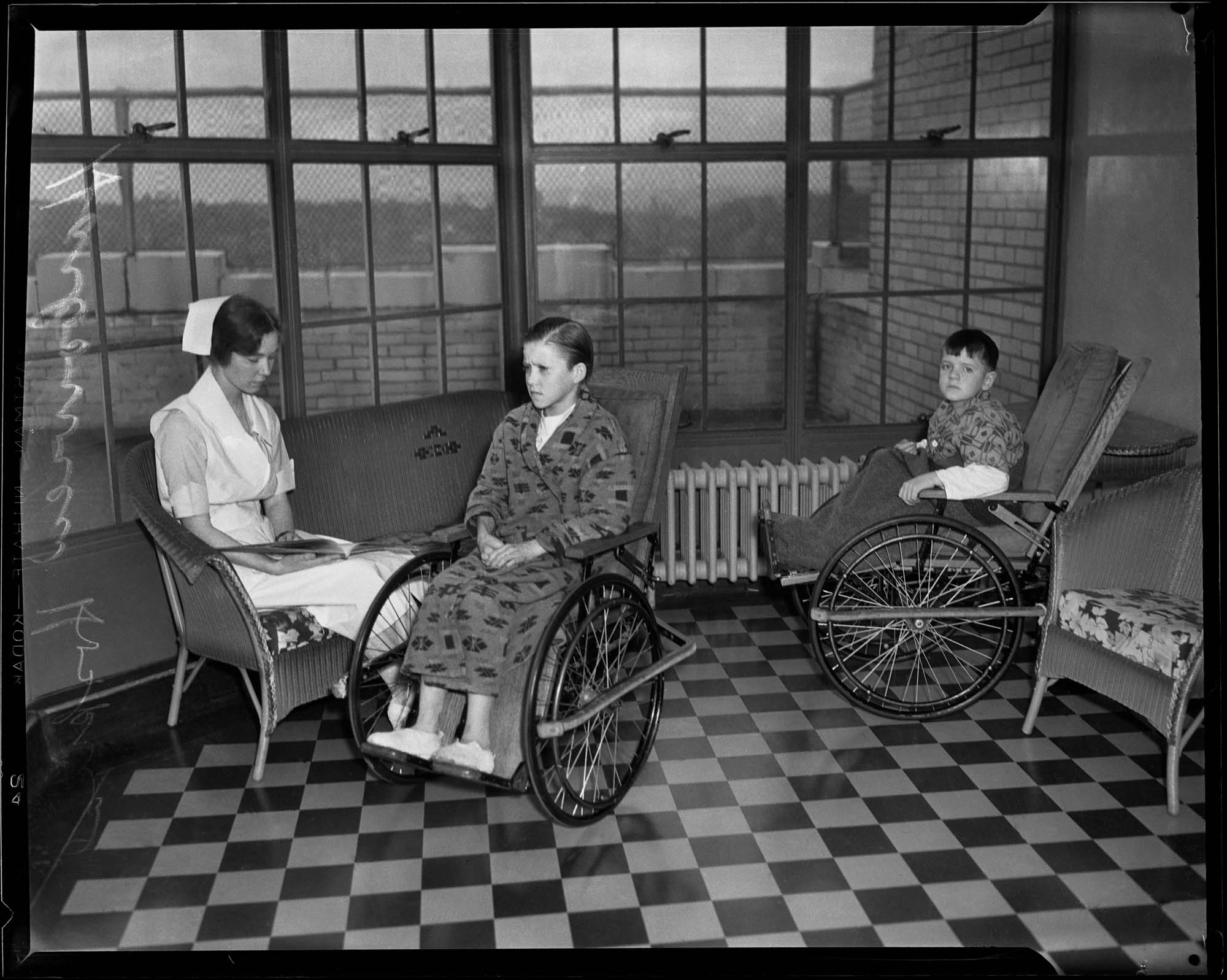 Image of Nurse reading to boys in wheelchairs at Harborview Hospital, Seattle, 1933