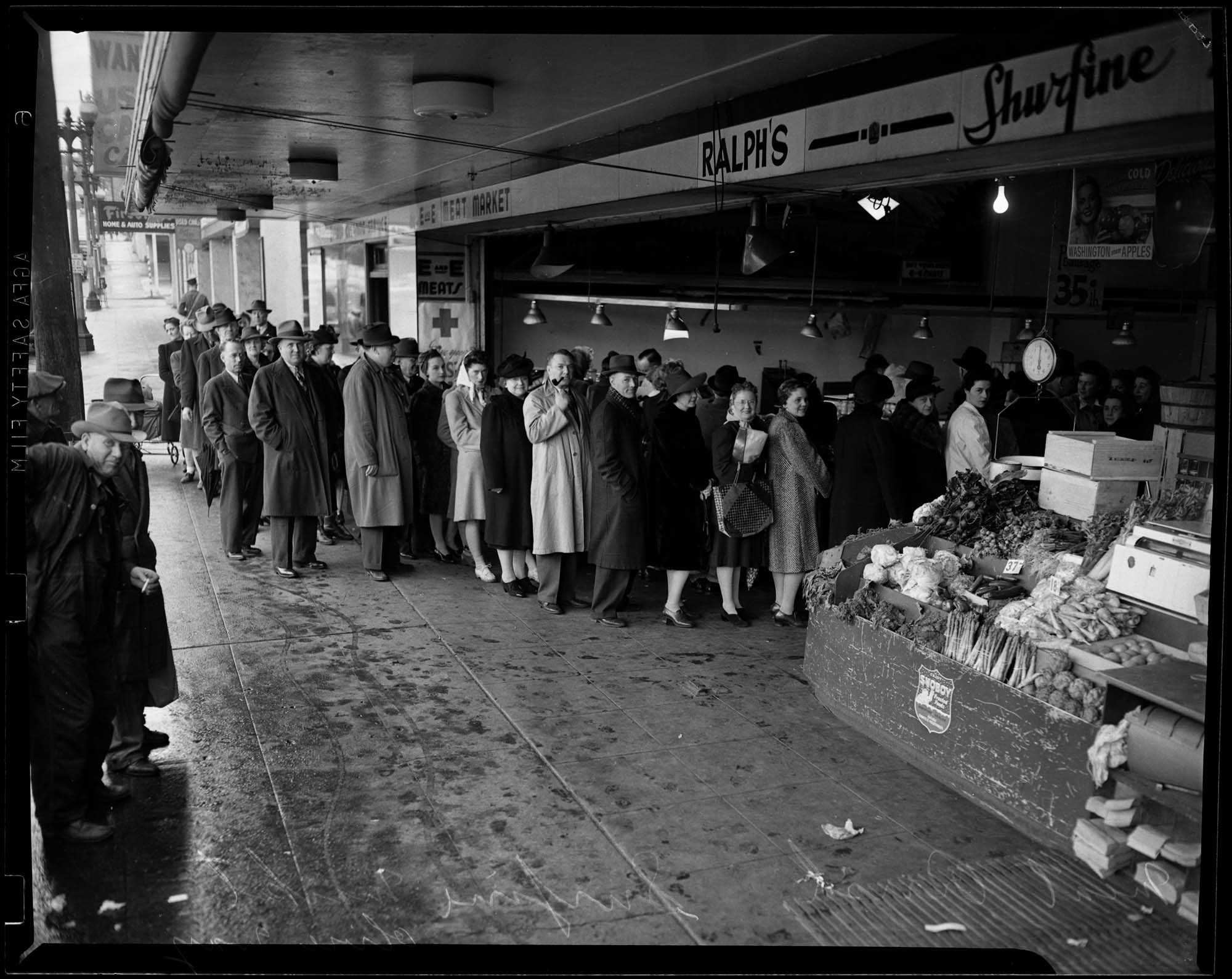 Image of Shoppers lined up in front of E&E Meat Market on Olive Way for meat during wartime rationing, 1943