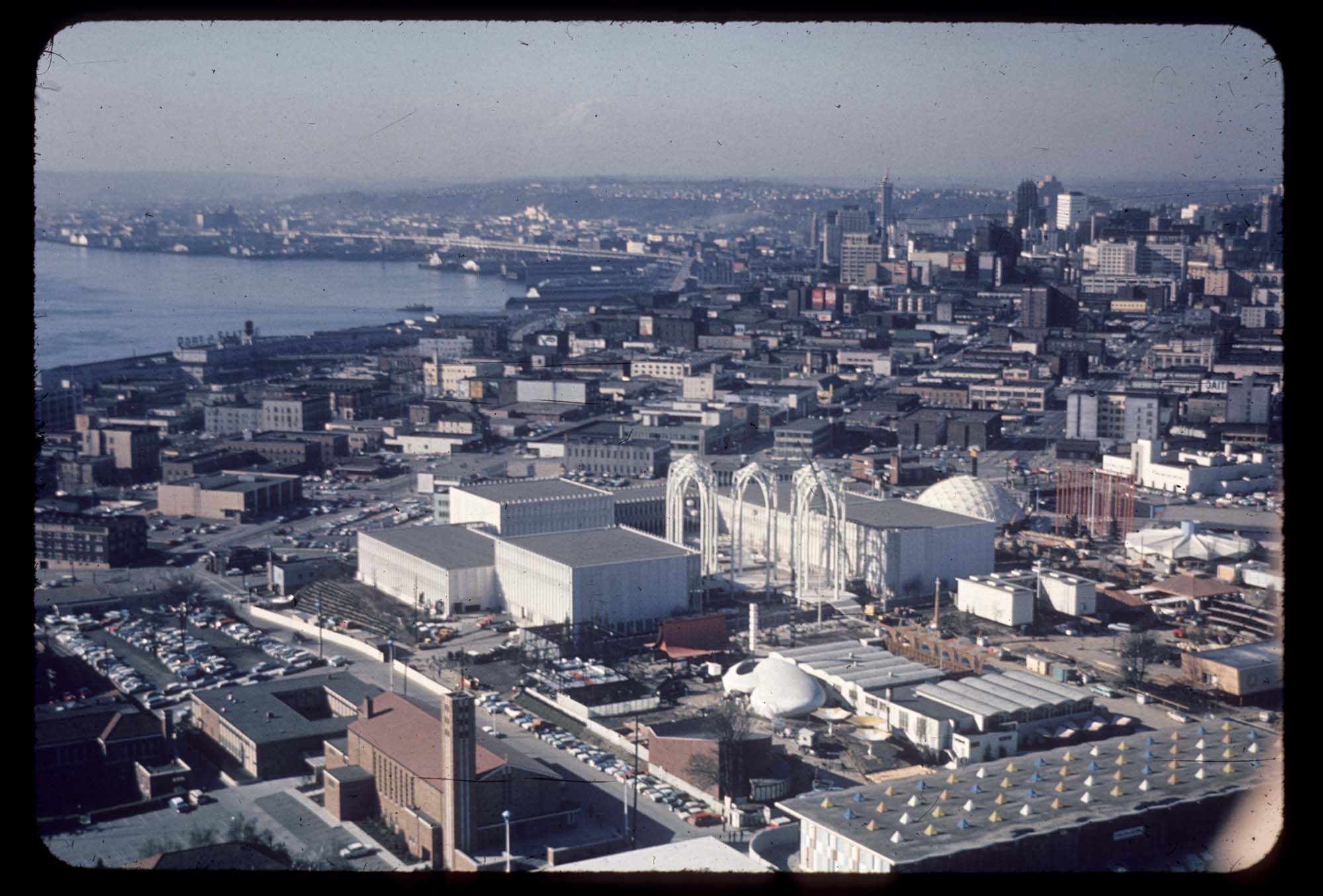 Image of Aerial view, looking northwest, of the U.S. Science Pavilion and the Seattle World's Fair grounds, with Elliott Bay, 1962