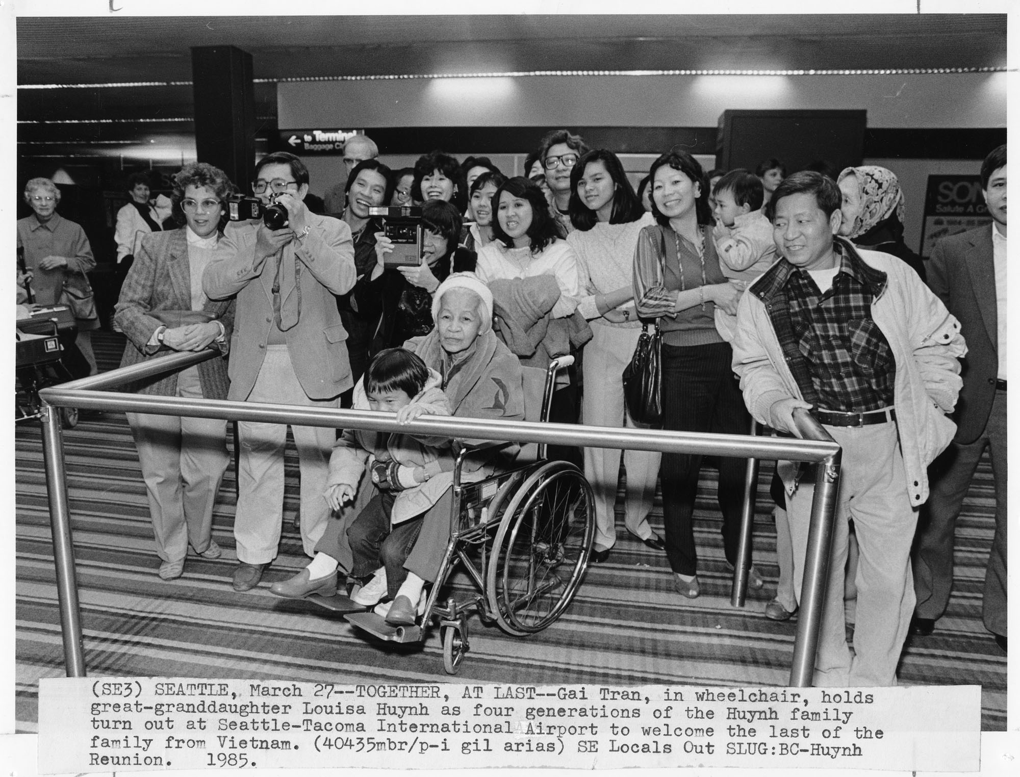 Image of Huynh family waiting to greet family from Vietnam at Sea-Tac Airport, March 25, 1985