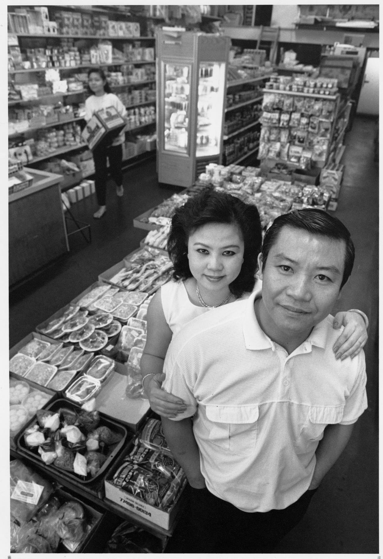 Image of Mau Duc and Cuc Nguyen working at New Saigon Market, Seattle, December 1990