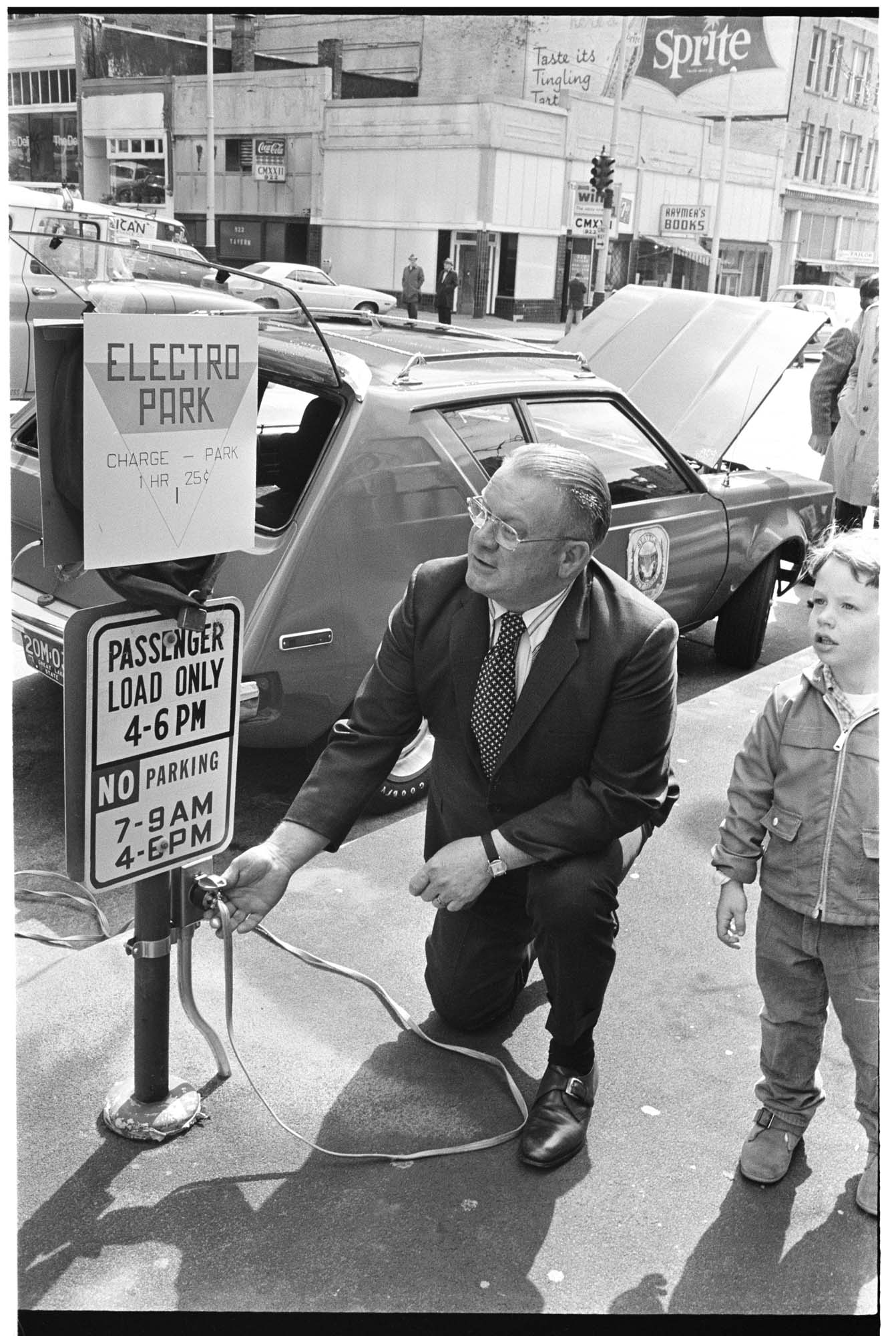 Image of City Light superintendent Gordon Vickery charging an electric car at a parking meter, Seattle, May 3, 1973