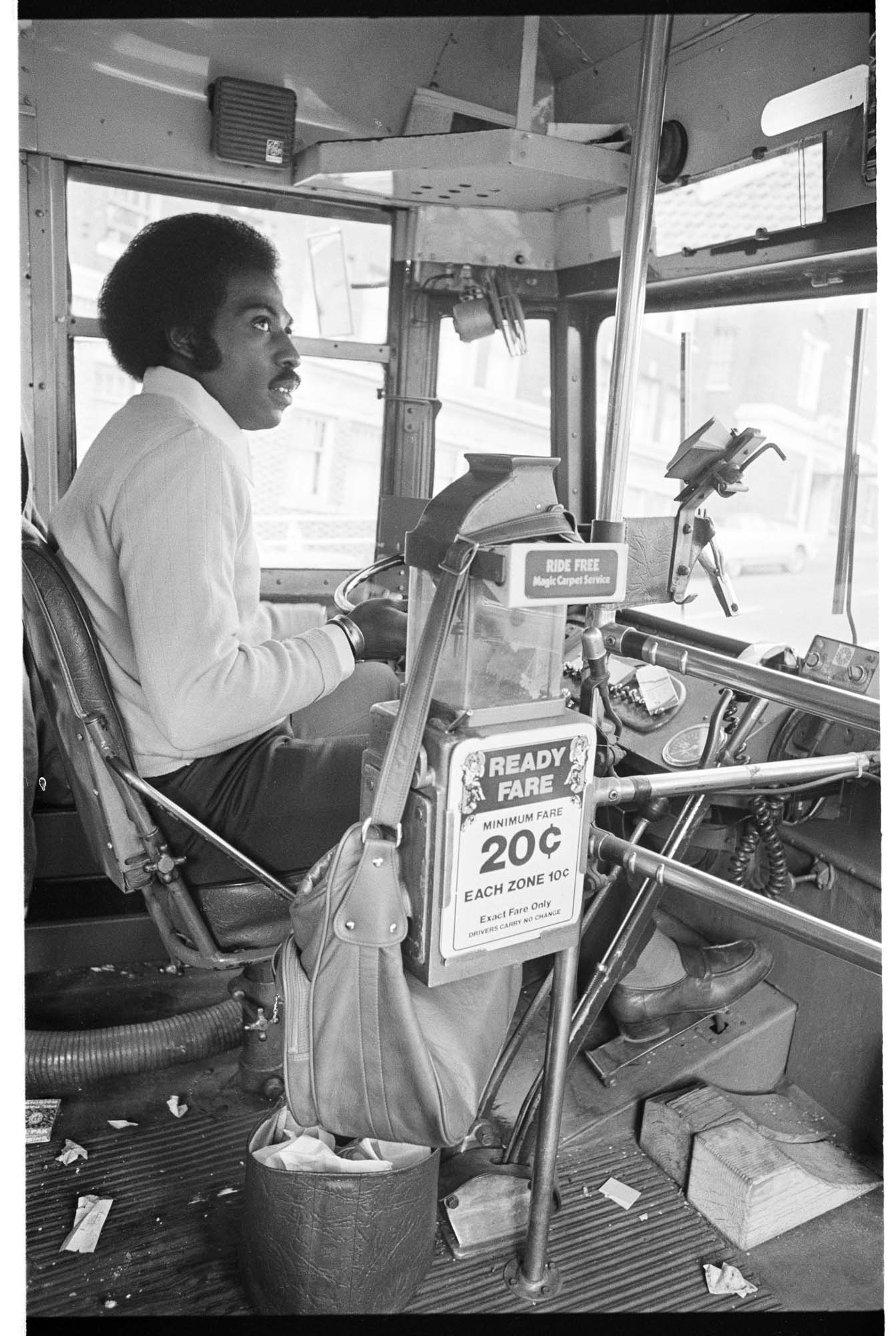 Image of Curtis Robinson at wheel of Metro trolley bus, Seattle, November 1975