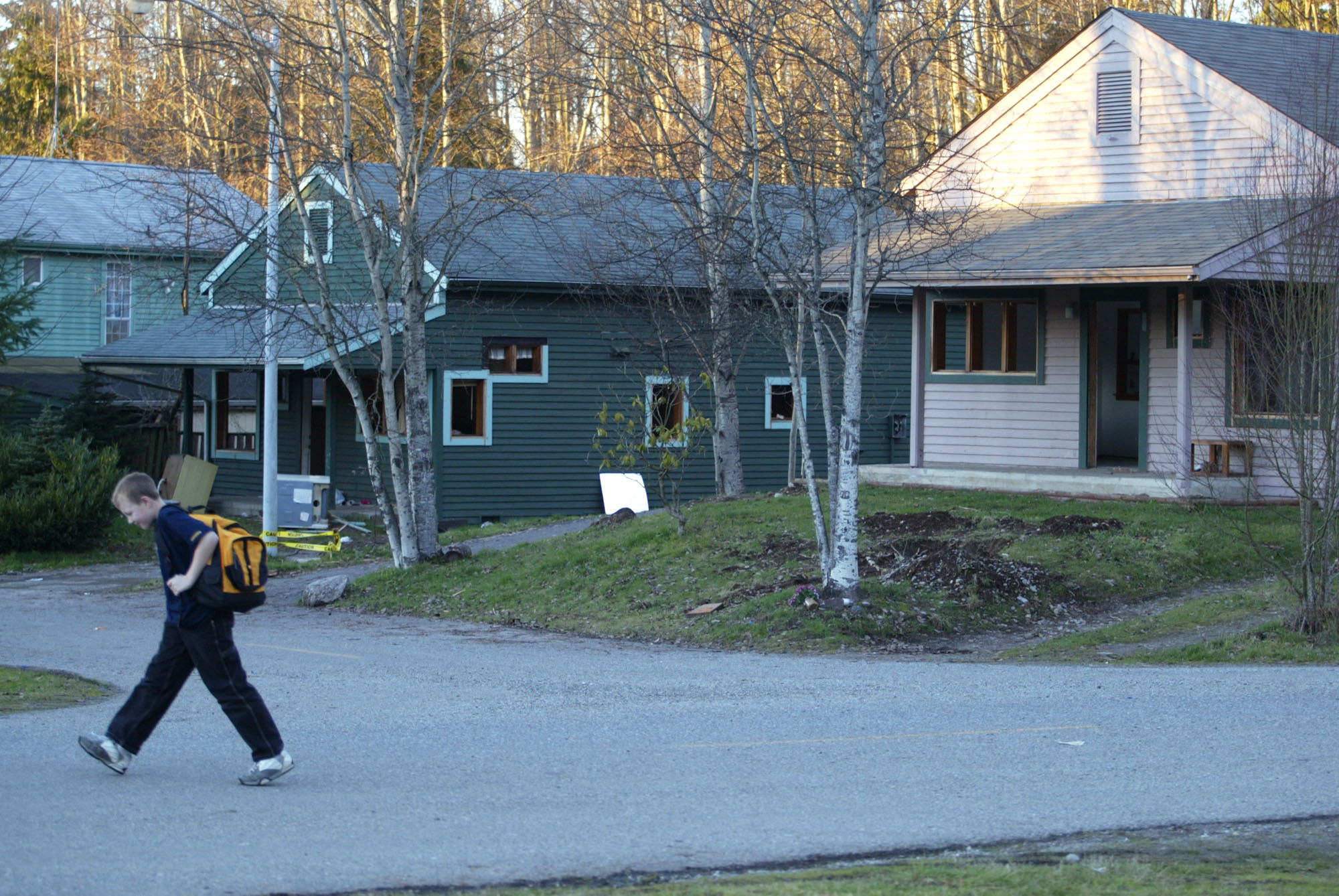 Image of Larry Yanity walking past homes to be razed for new casino, Arlington, January 9, 2003