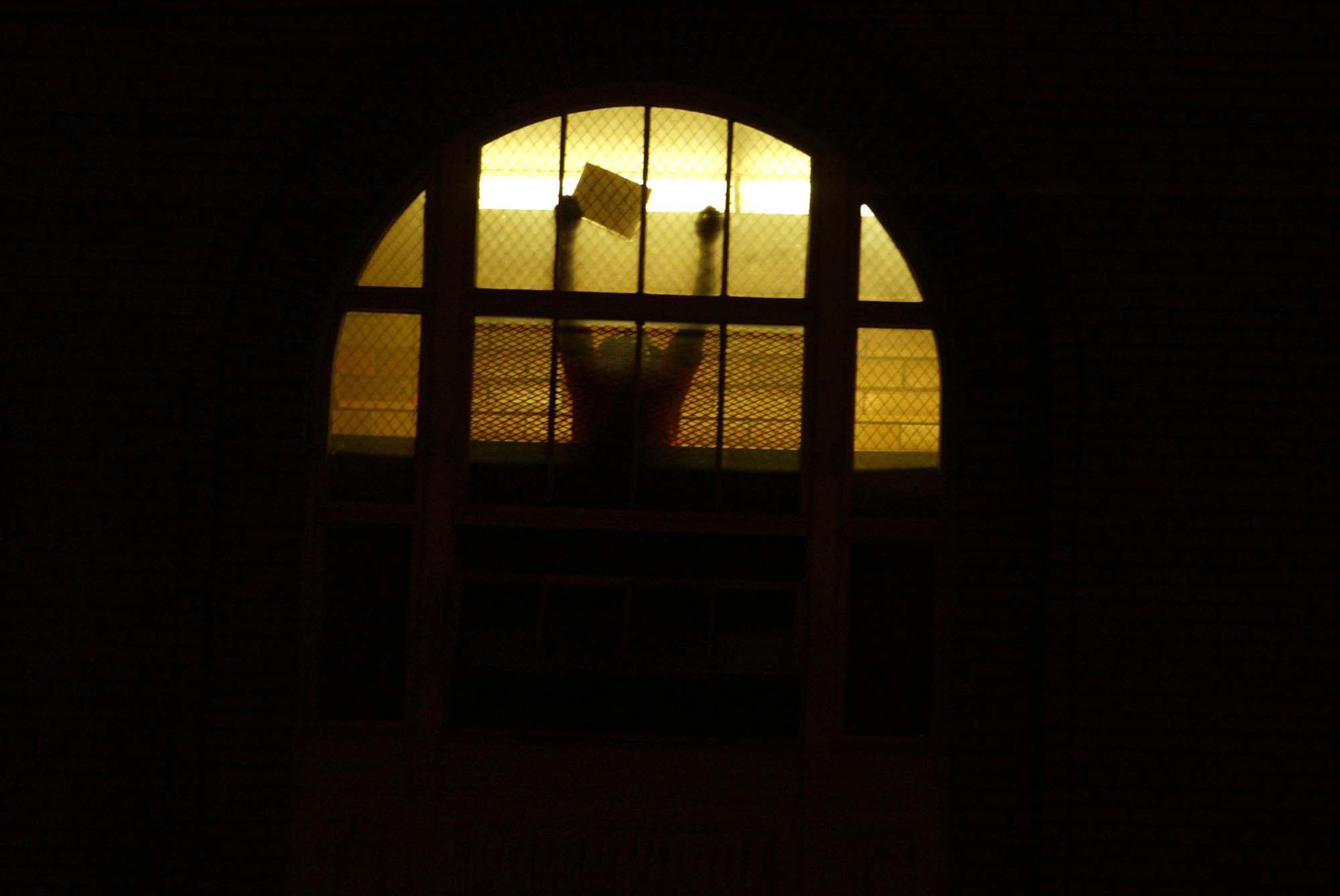 Image of INS detainee responding to people protesting new INS policies, Seattle, January 13, 2003