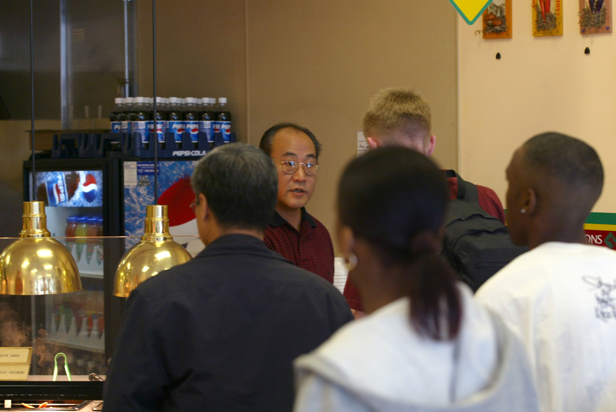Image of Owner Jae Oh waiting on customers at Magic Garden Chinese Eatery, Seattle, January 16, 2003
