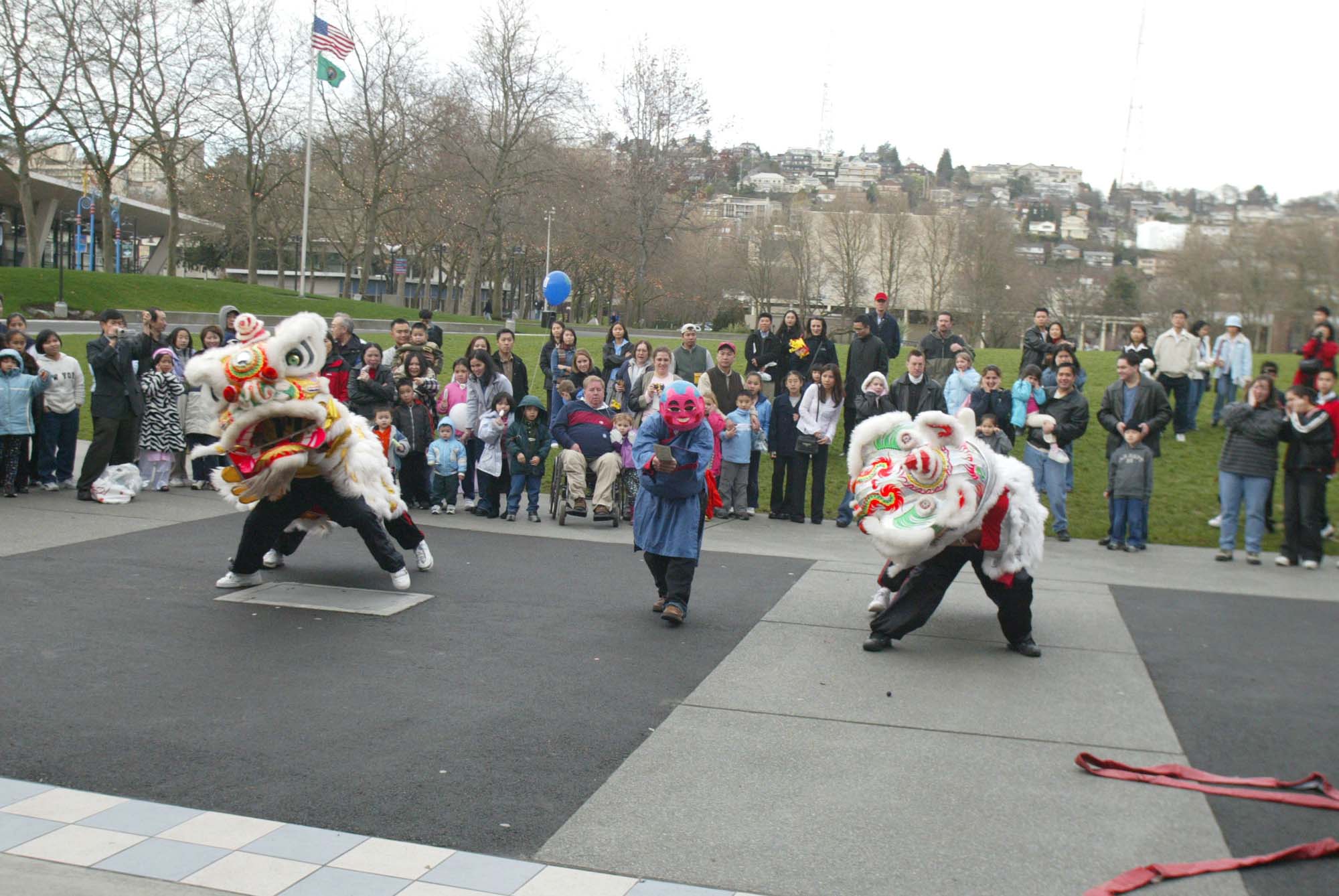 Image of Spectators watch Lion Dance performers at Tet festival at Seattle Center, January 25, 2003