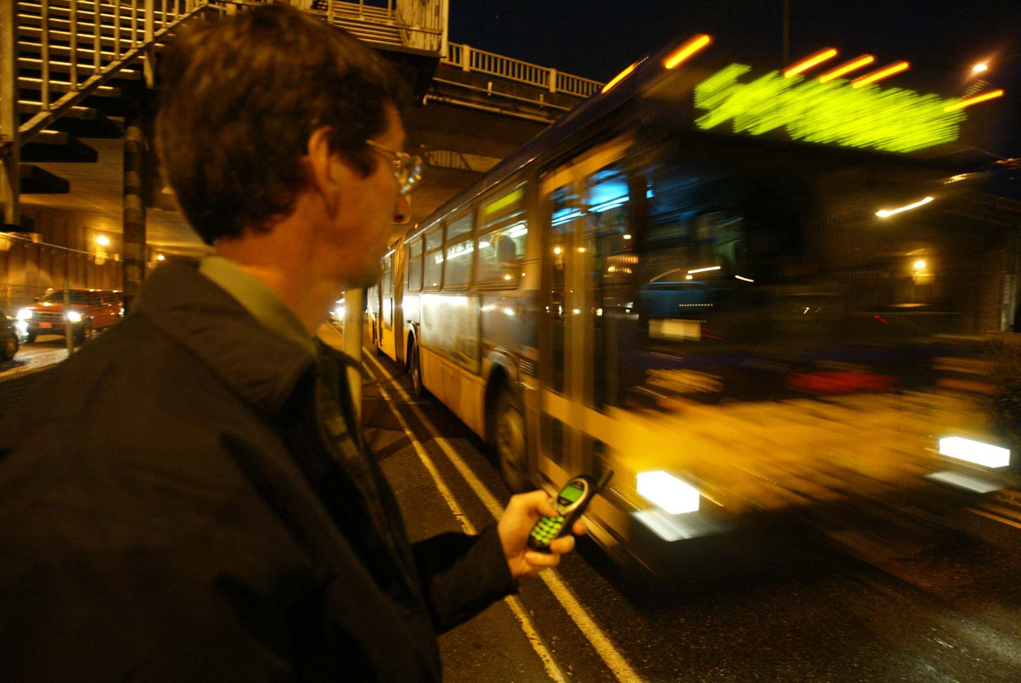 Image of Mark Hallenback using the Mybus program on his phone, January 28, 2003