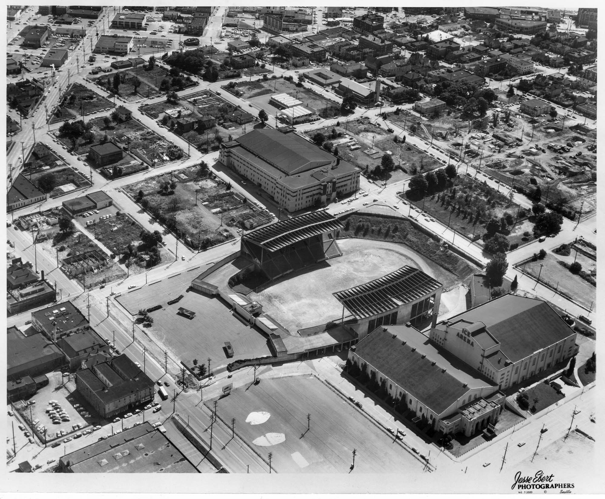 Image of Aerial view of Washington State Coliseum construction site showing original buildings, Seattle, 1960