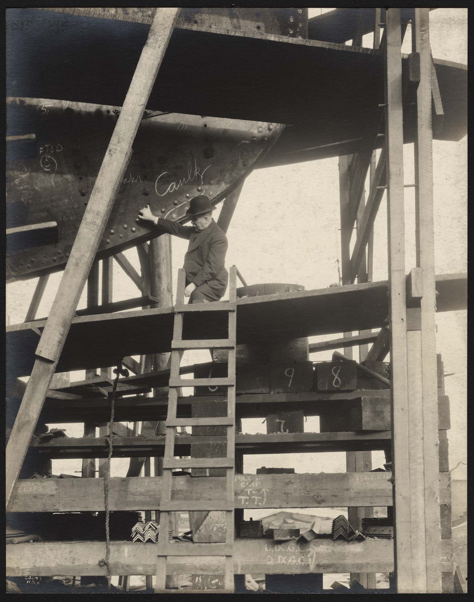 Image of David Rodgers examining hull of ship at Skinner & Eddy shipyard, Seattle, circa 1918