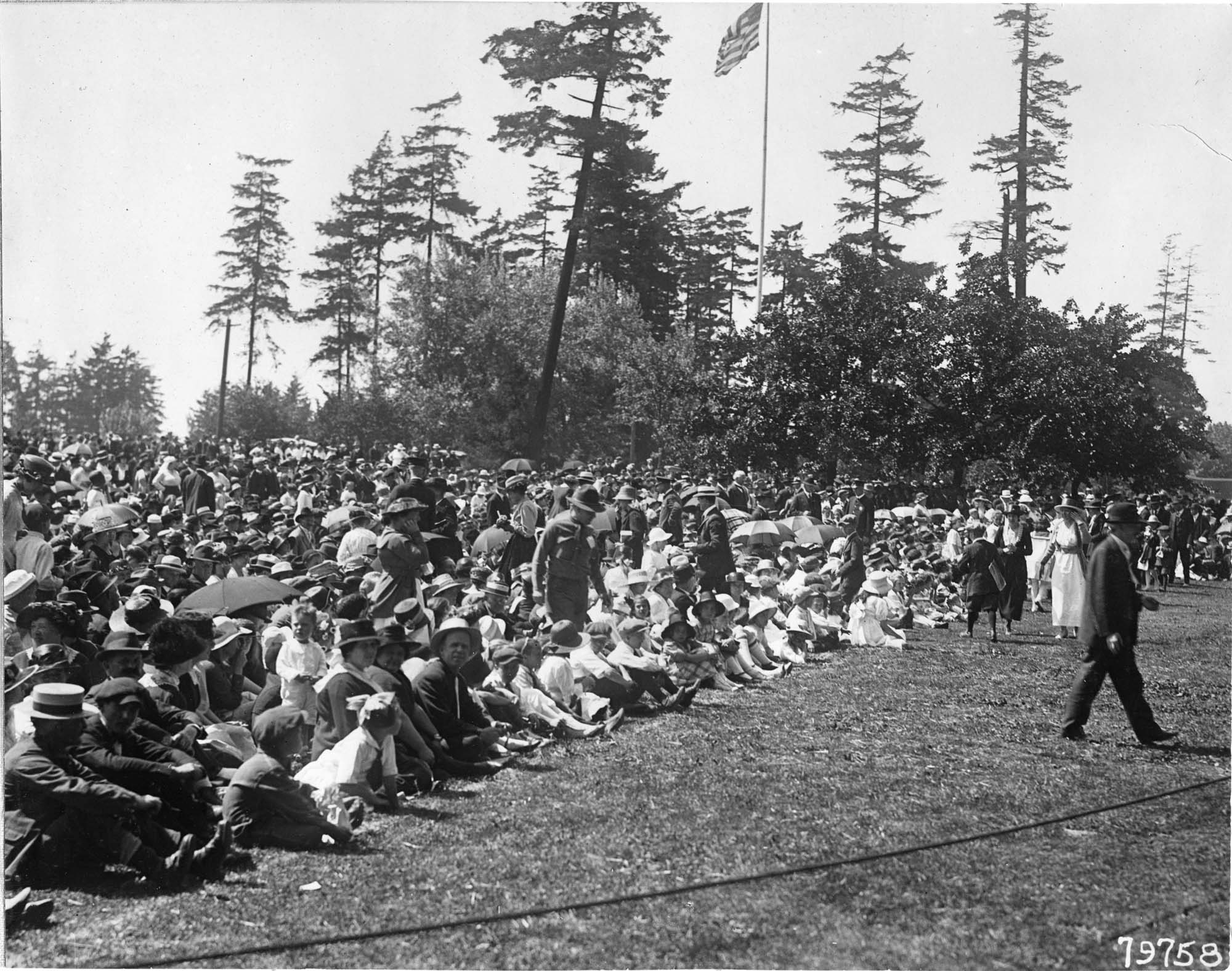 Image of Spectators seated on lawn for the 