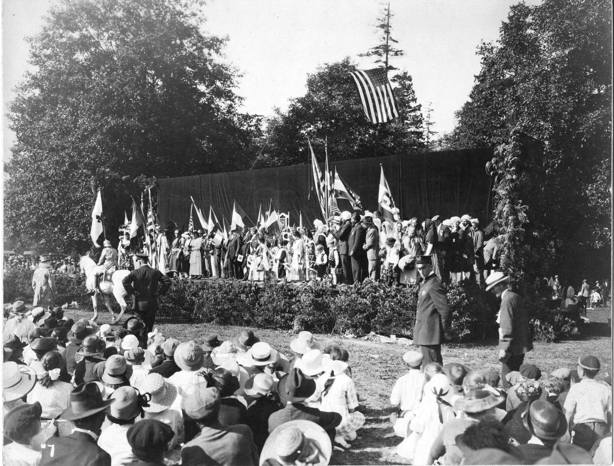 Image of Spectators watching the full cast of performers onstage at the 