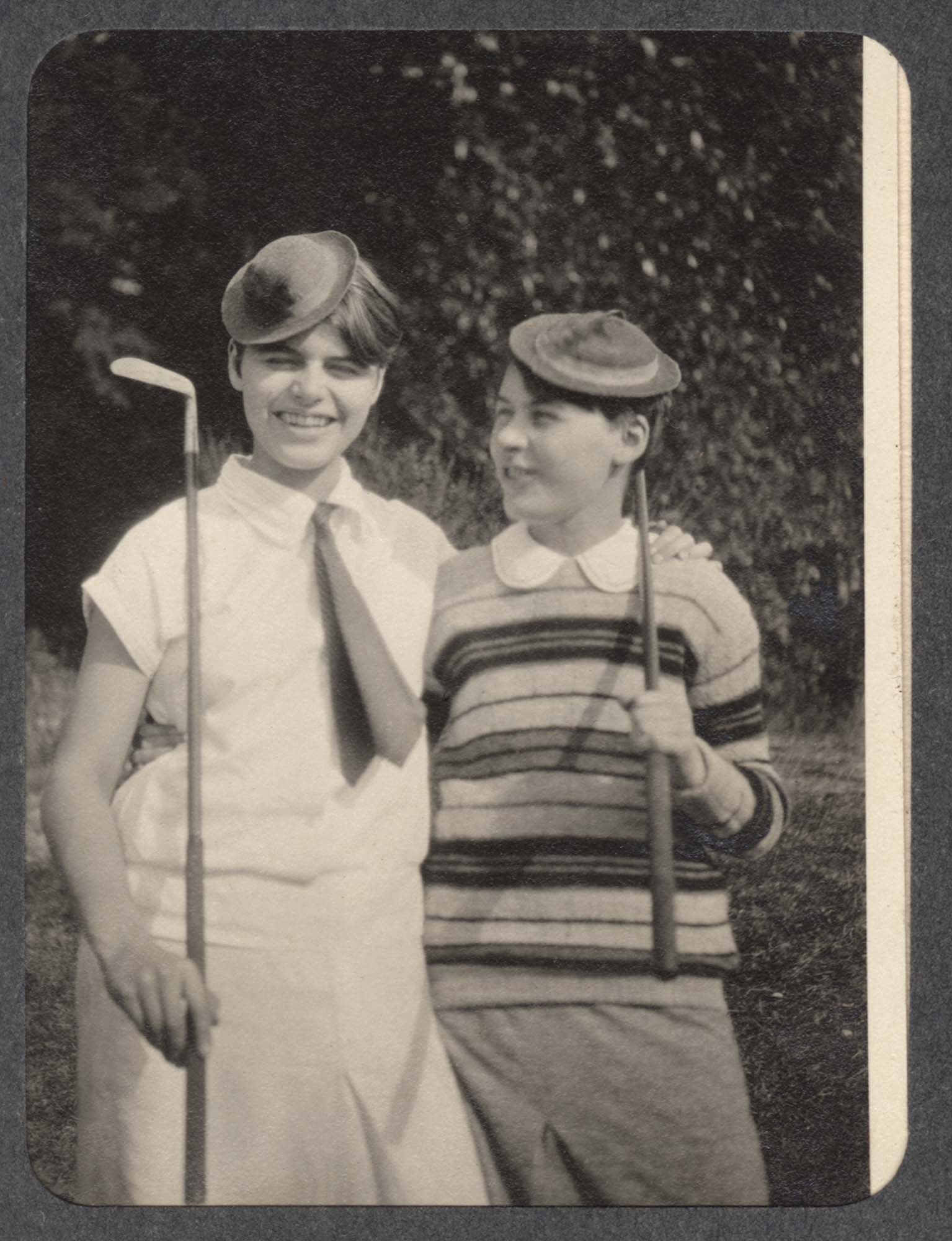 Image of Two children holding golf clubs, ca. 1920