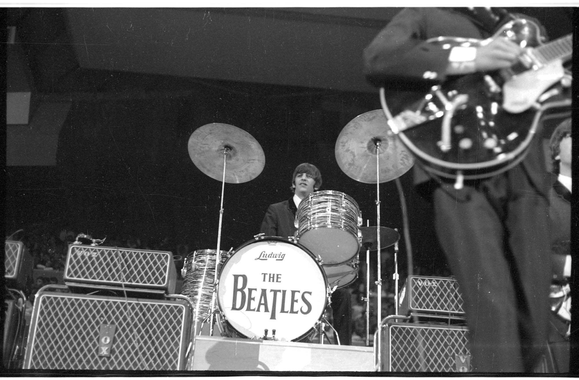 Image of Ringo Starr playing drums during the Beatles concert at Seattle Center Coliseum, August 21, 1964
