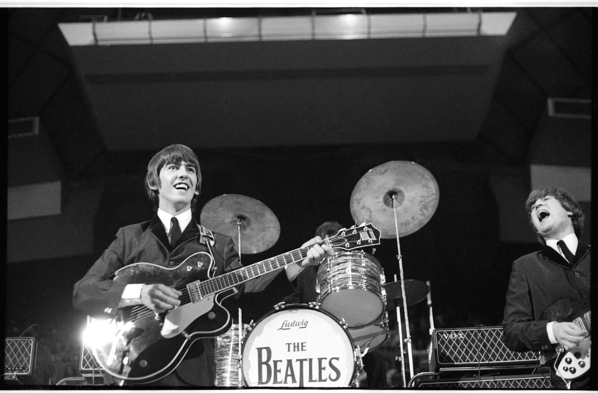 Image of George Harrison and John Lennon performing at the Beatles concert, Seattle Center Coliseum, August 21, 1964