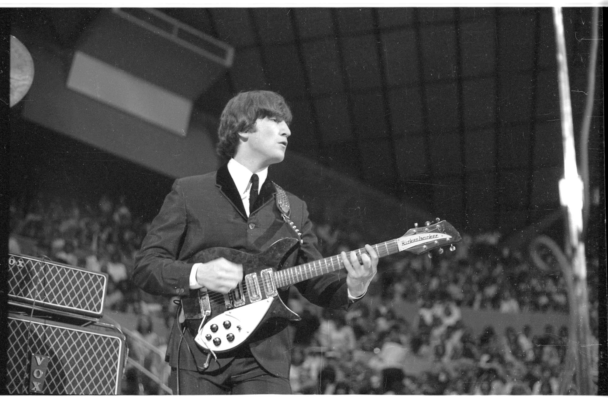 Image of John Lennon performing at the Beatles concert, Seattle Center Coliseum, August 21, 1964